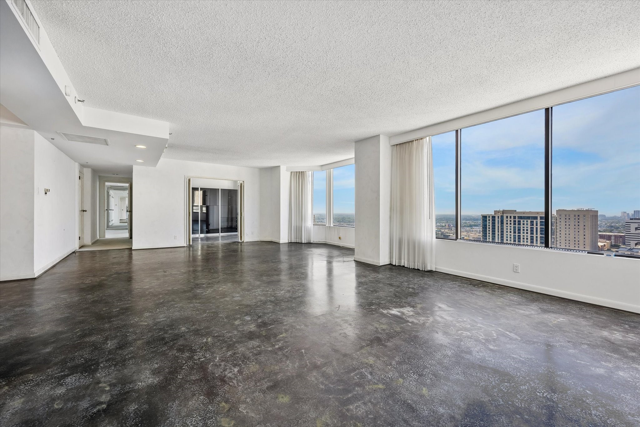 Multiple window bays bring daylight across the open living and dining areas. Connected spaces provide room to gather, entertain and create distinct areas for daily activities, with the skyline as a backdrop.