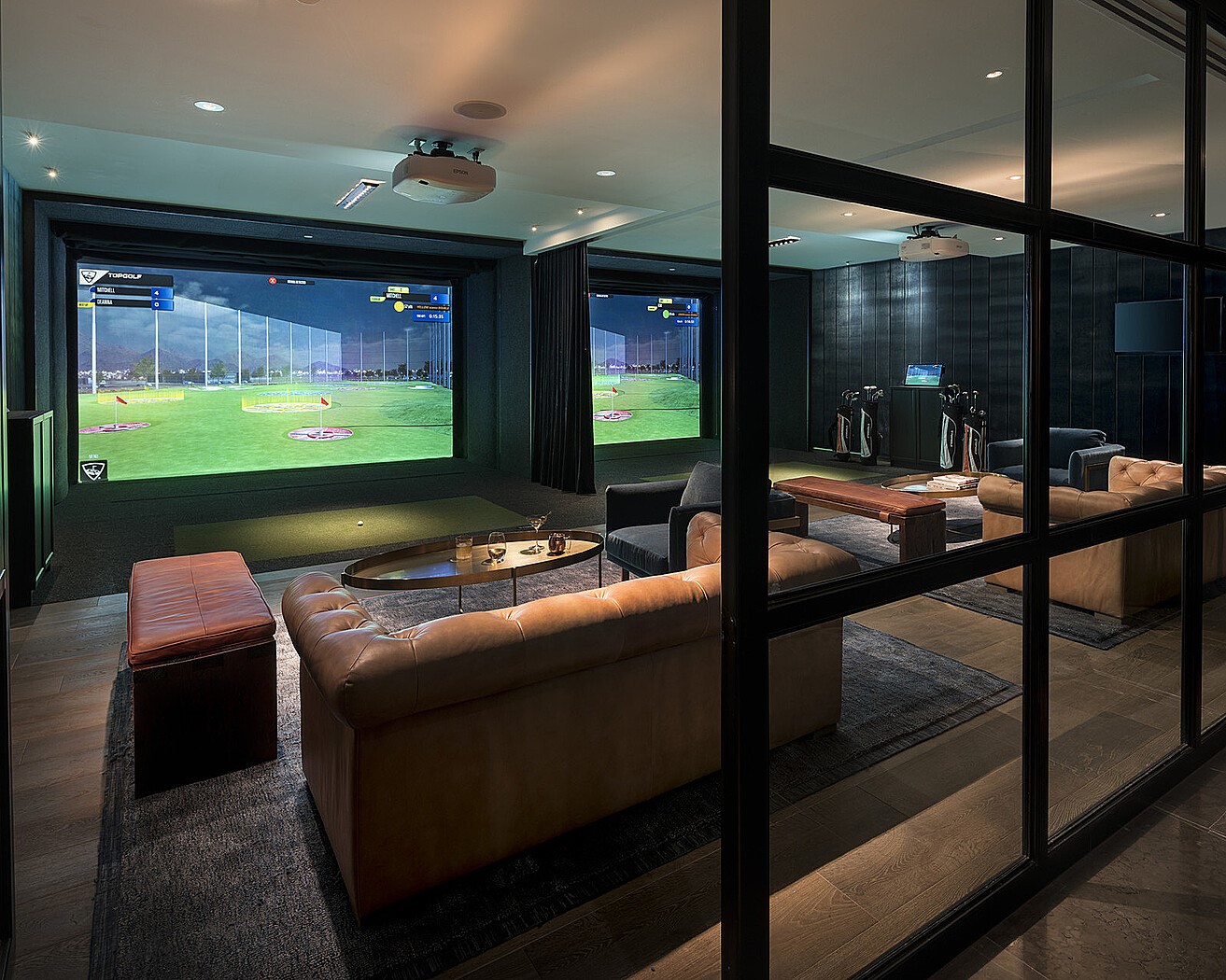 Private golf simulator lounge with plush seating, designed for year-round practice and entertainment.