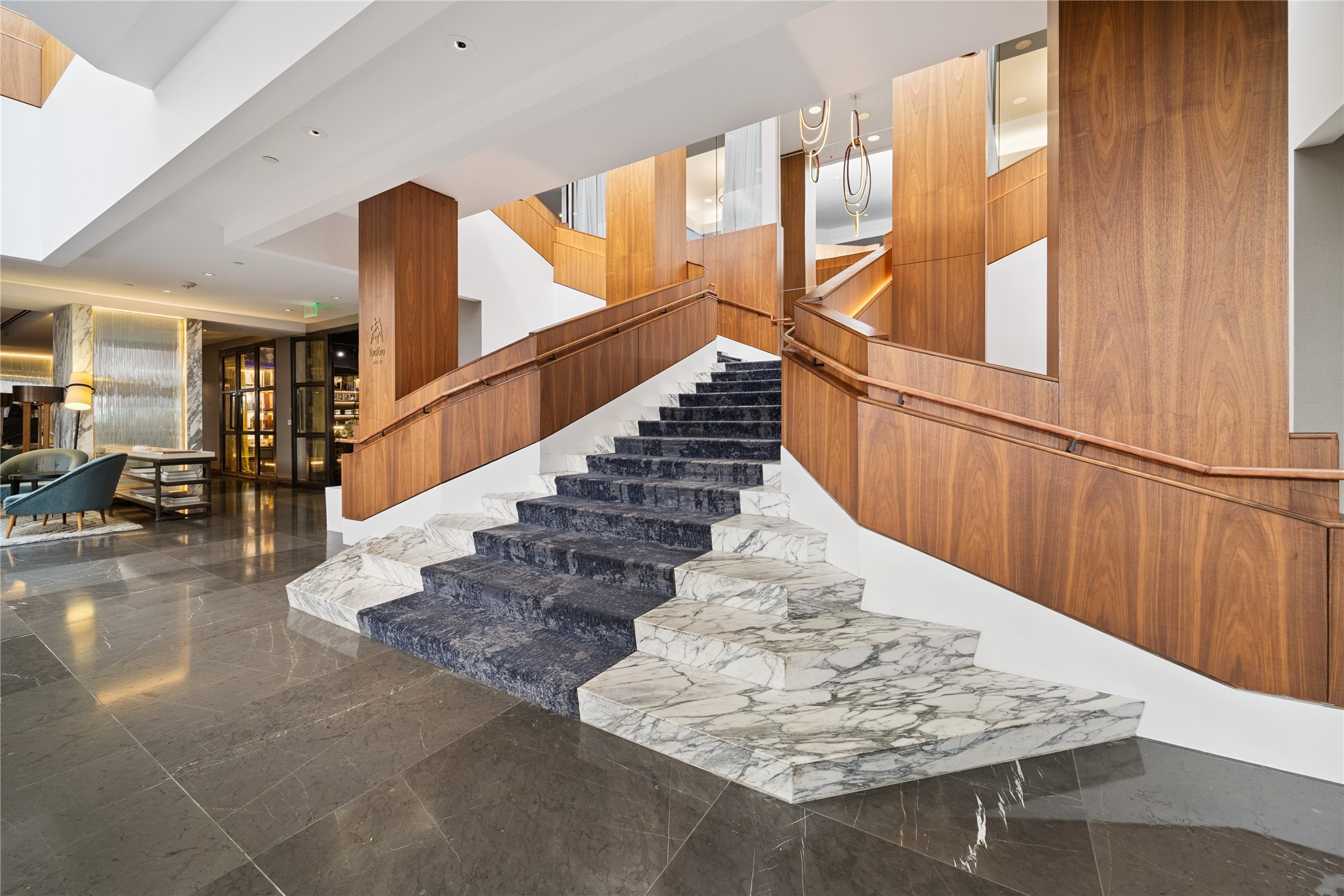 The hotel lobby showcases elegant finishes with marble, wood accents, and sculptural stairways, underscoring why the Four Seasons is often called Houstons living room. Residents enjoy private access yet remain connected to the vibrancy of the hotel and its curated amenities.