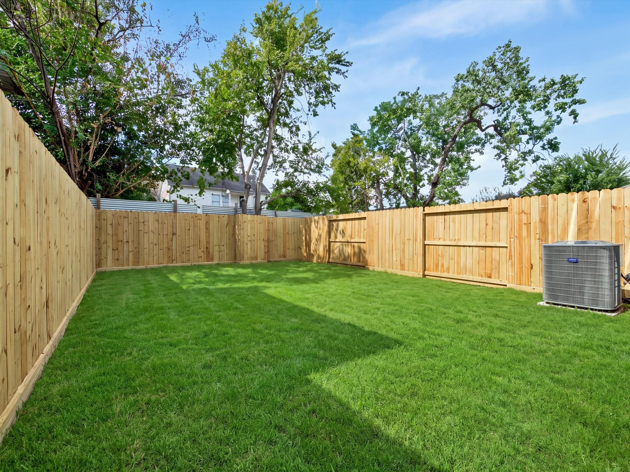A remarkably spacious, privately fenced backyard, an important advantage compared to many urban townhomes.