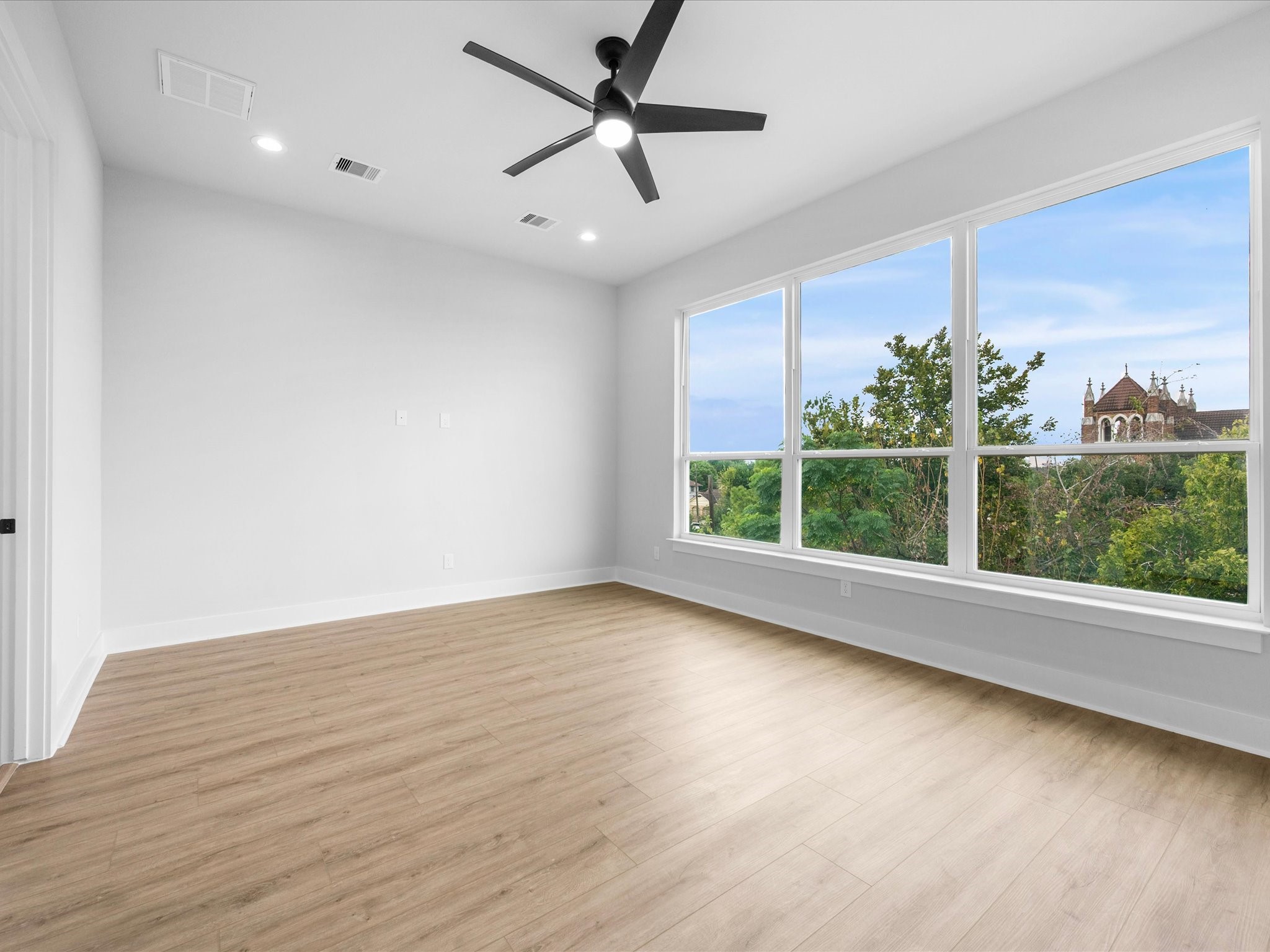 Generous windows connect the interior with the surrounding cityscape, filling the home with natural light and highlighting its modern aesthetic.