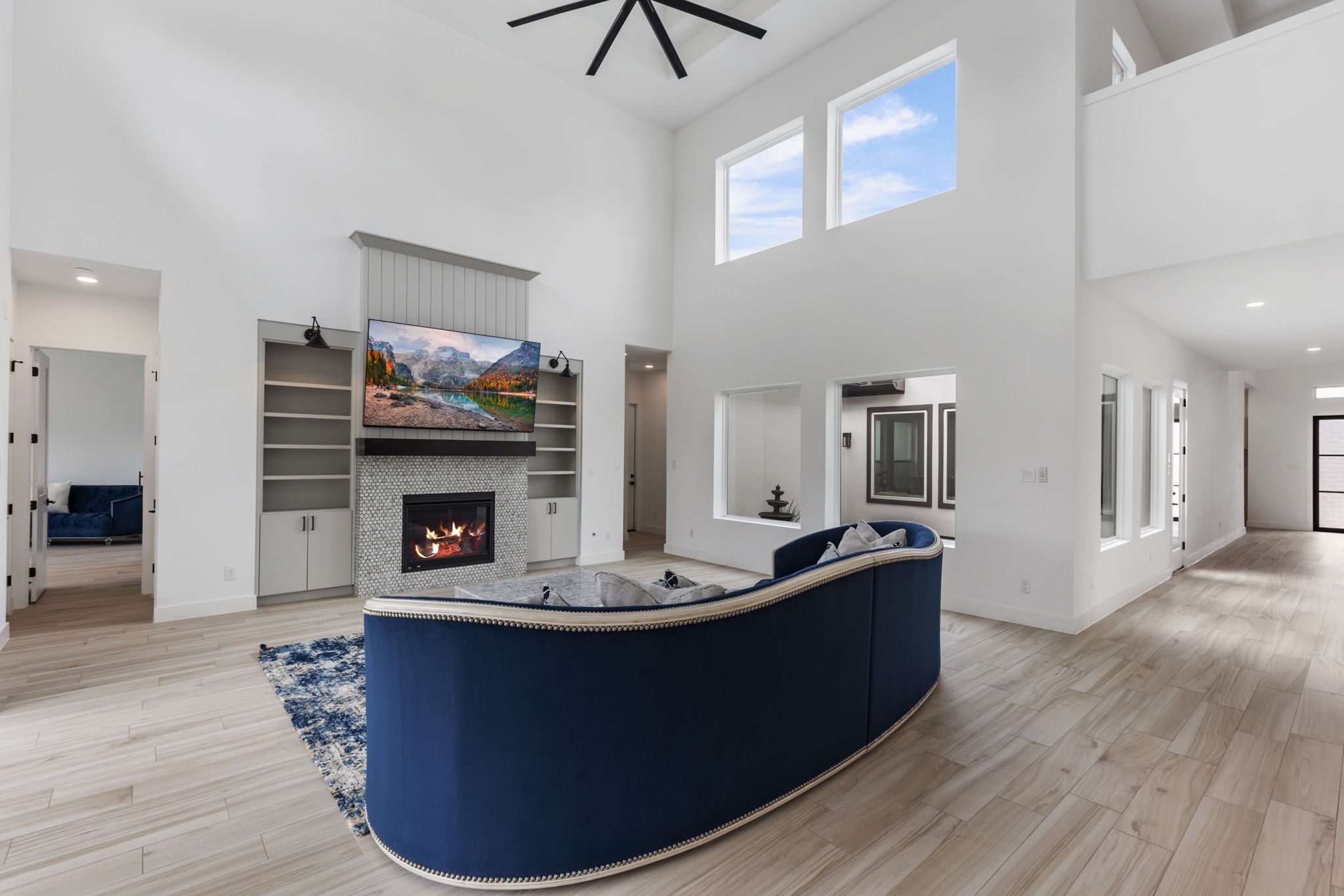 Large living room with built-in flanking the fireplace.