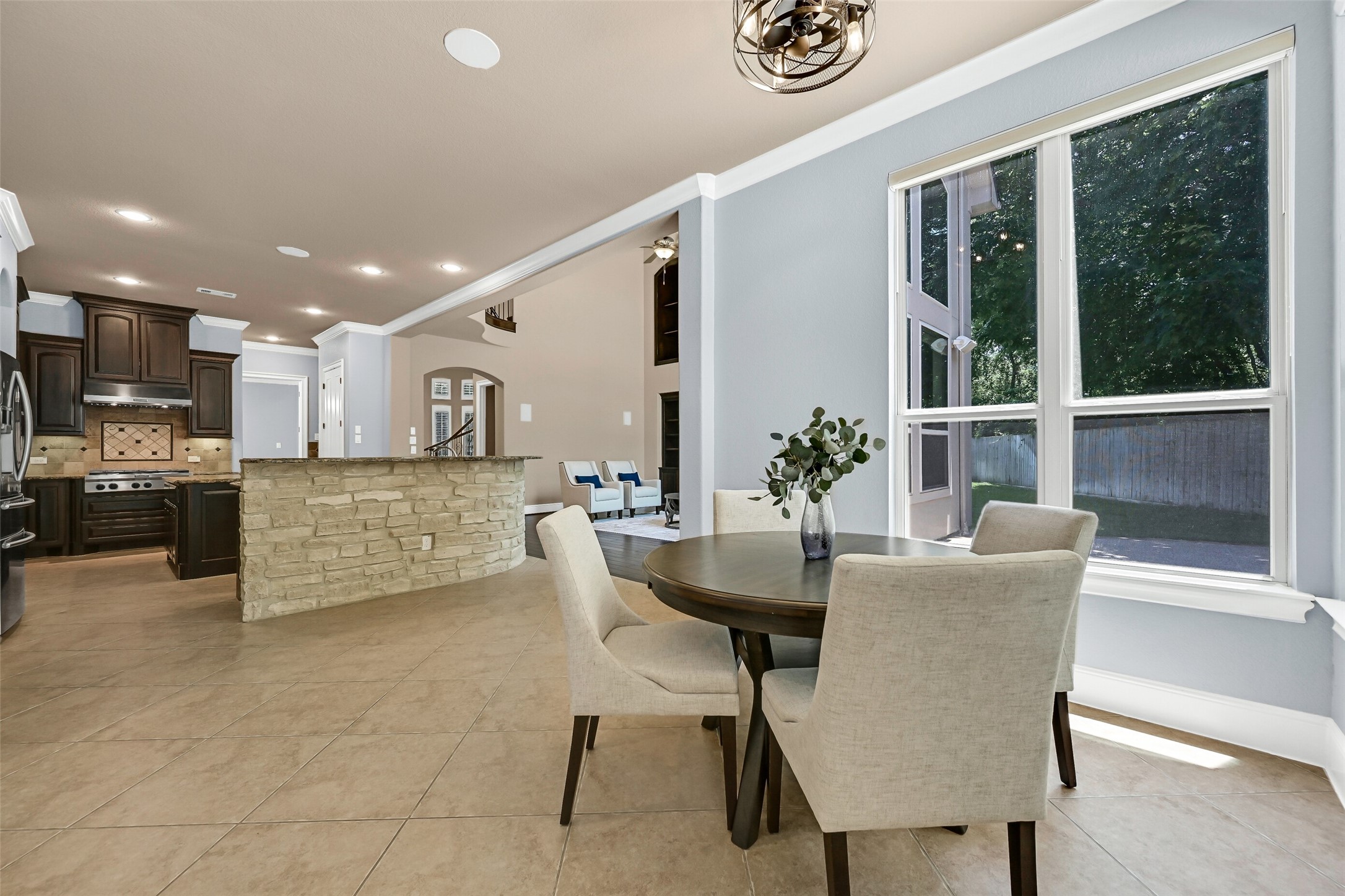With natural light streaming in from multiple walls of windows, the breakfast area feels both open and inviting while remaining seamlessly connected to the kitchen and family room, making it ideal for casual dining and morning coffee overlooking the backyard.