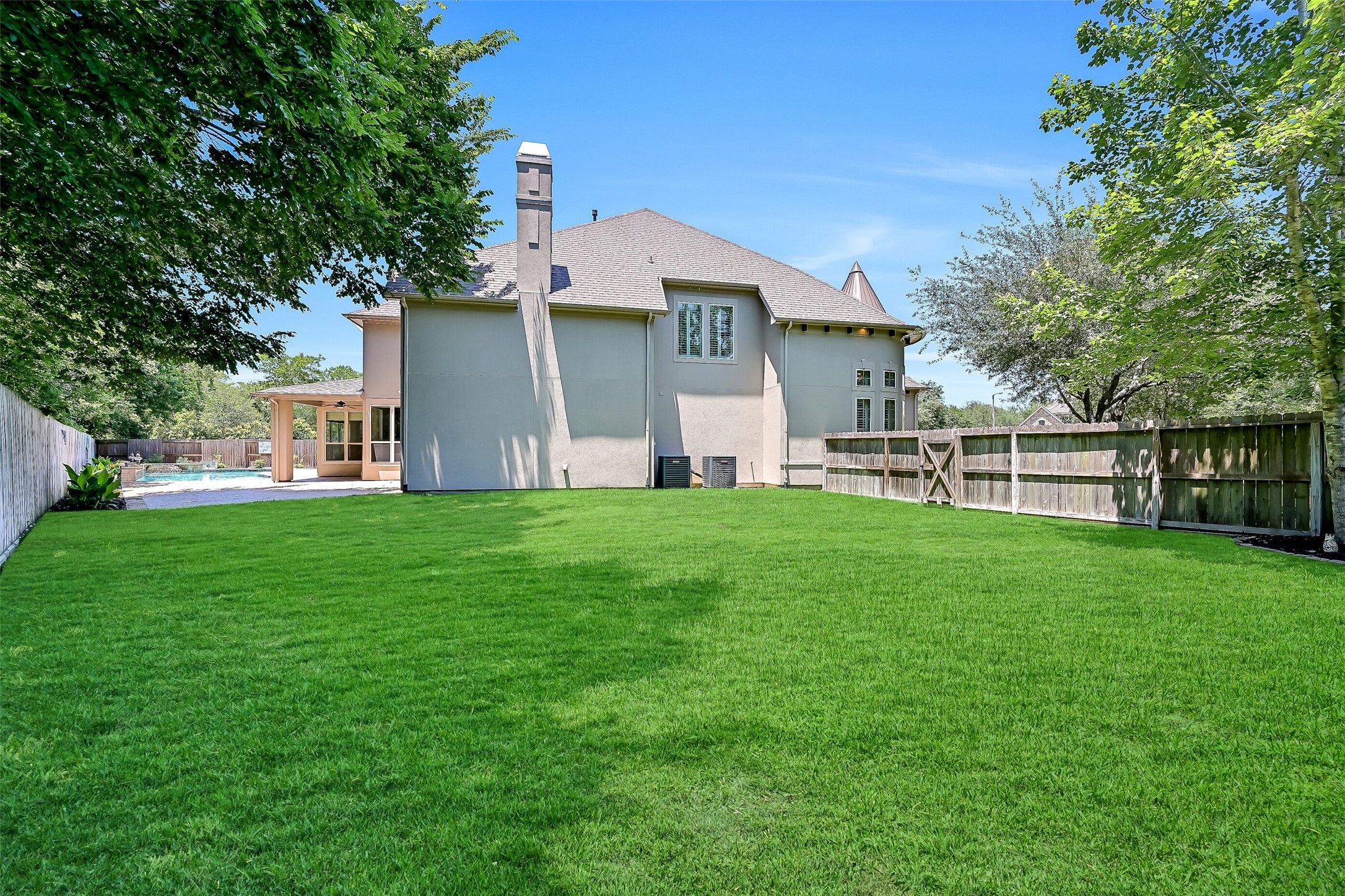 Set on a pie-shaped lot, the backyard also features a large side yard with lush green space, full irrigation system, and plenty of room for pets, play, or future outdoor additions.
