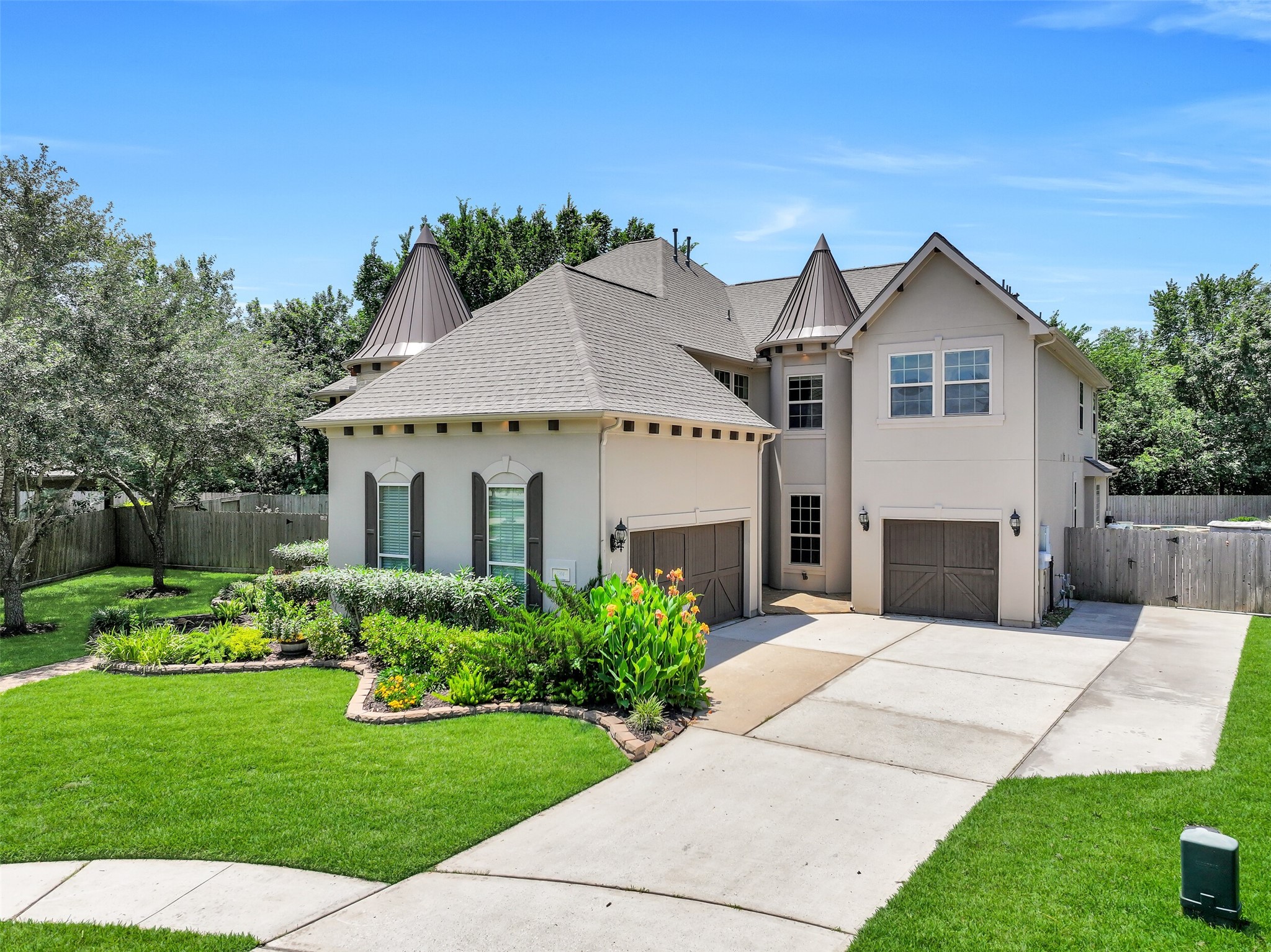 From the extended double-wide driveway to the separate single and two-car garage bays, every detail of the exterior was thoughtfully designed for both function and architectural impact. The all-stucco faade, mature landscaping, sprinkler system, and distinctive turret rooflines give the home a timeless, estate-style presence.