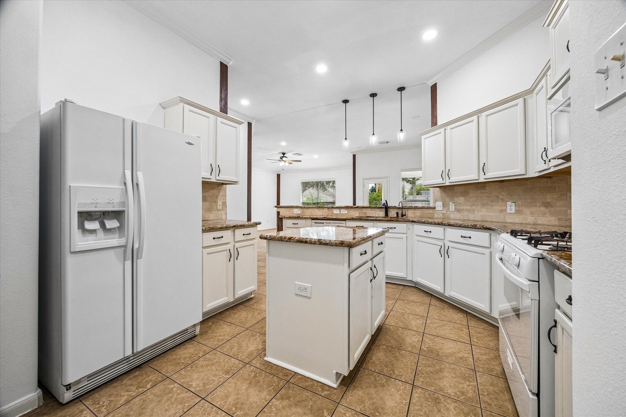 Bright and inviting kitchen with a central island offering extra storage, perfect for culinary enthusiasts.