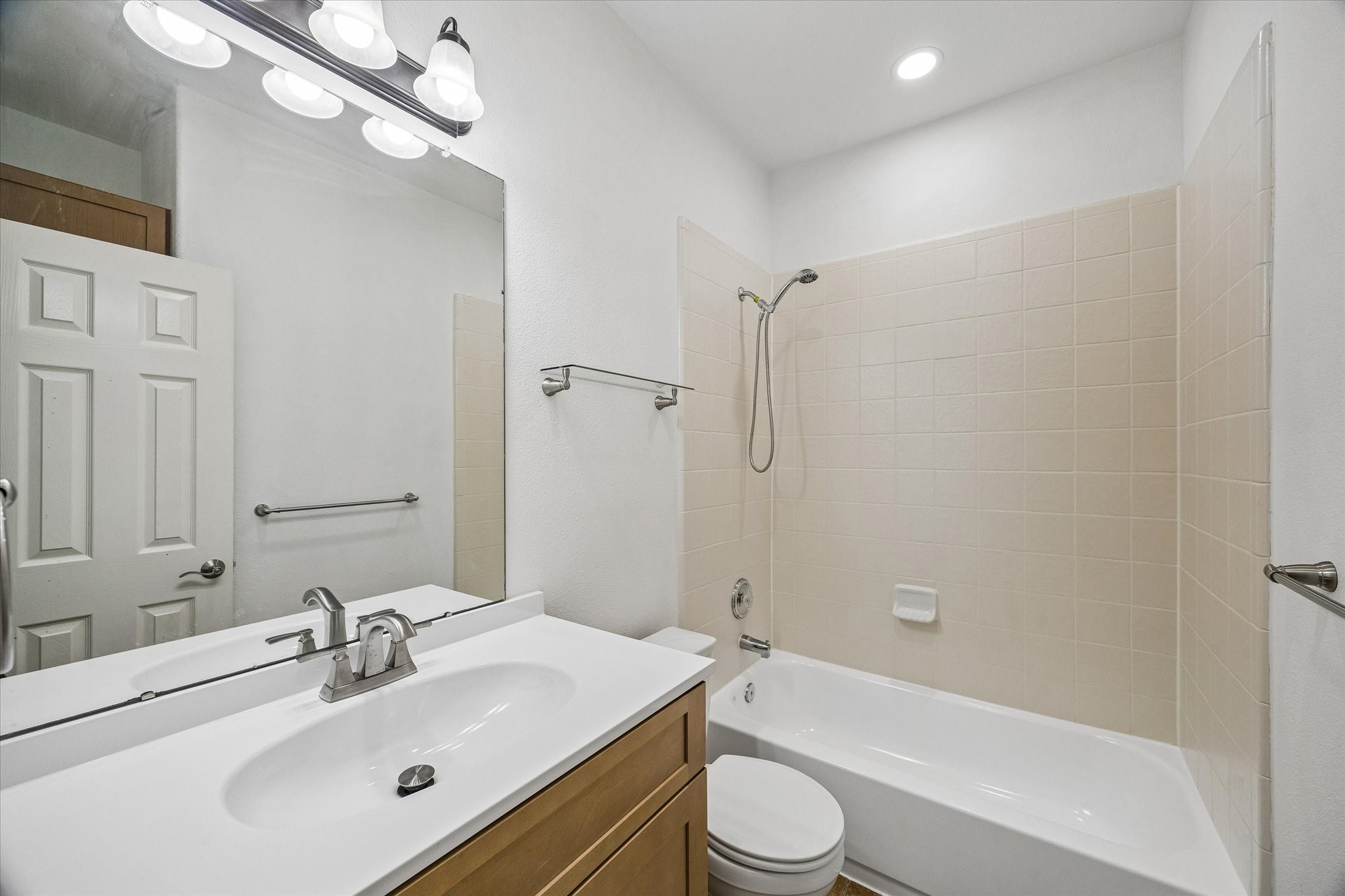 Experience modern comfort in the beautifully updated guest bathroom, featuring sleek fixtures and a fresh, inviting design.
