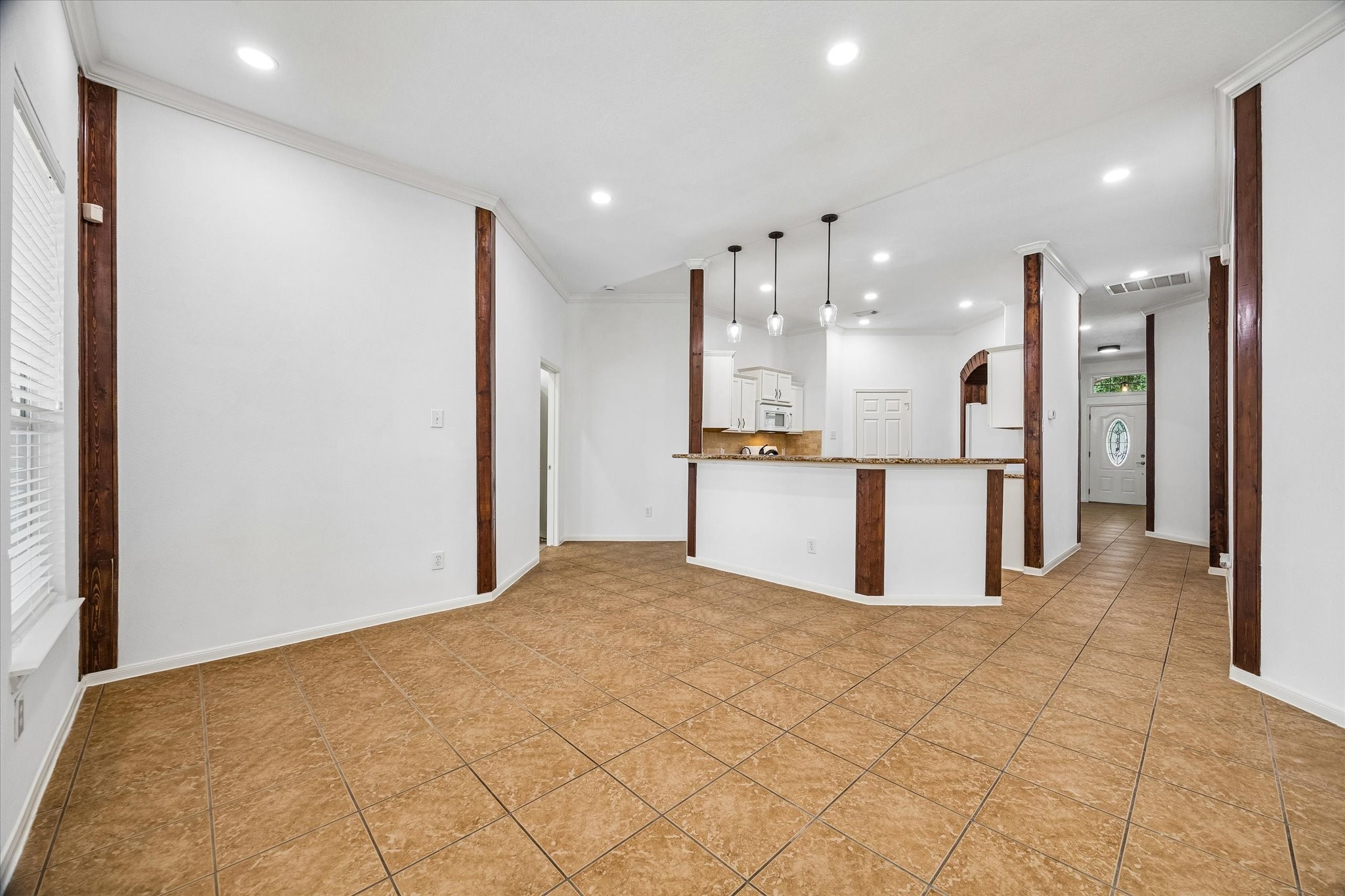 The bright breakfast and dining area boasts an inviting open floor plan seamlessly connected to the kitchen and living spaces, perfect for modern living and entertaining.
