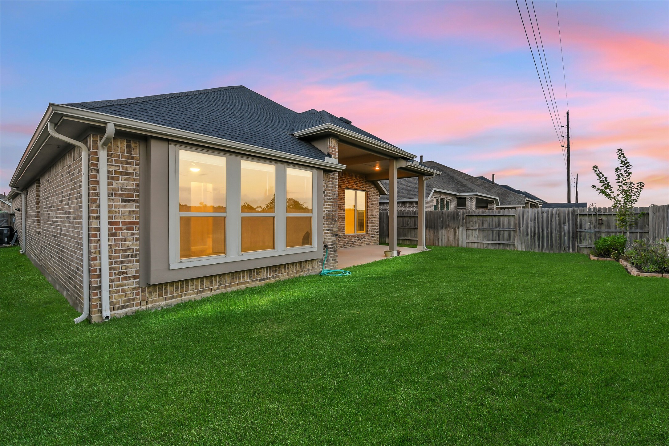 Established corner landscaping in the backyard adds to this home's beauty.