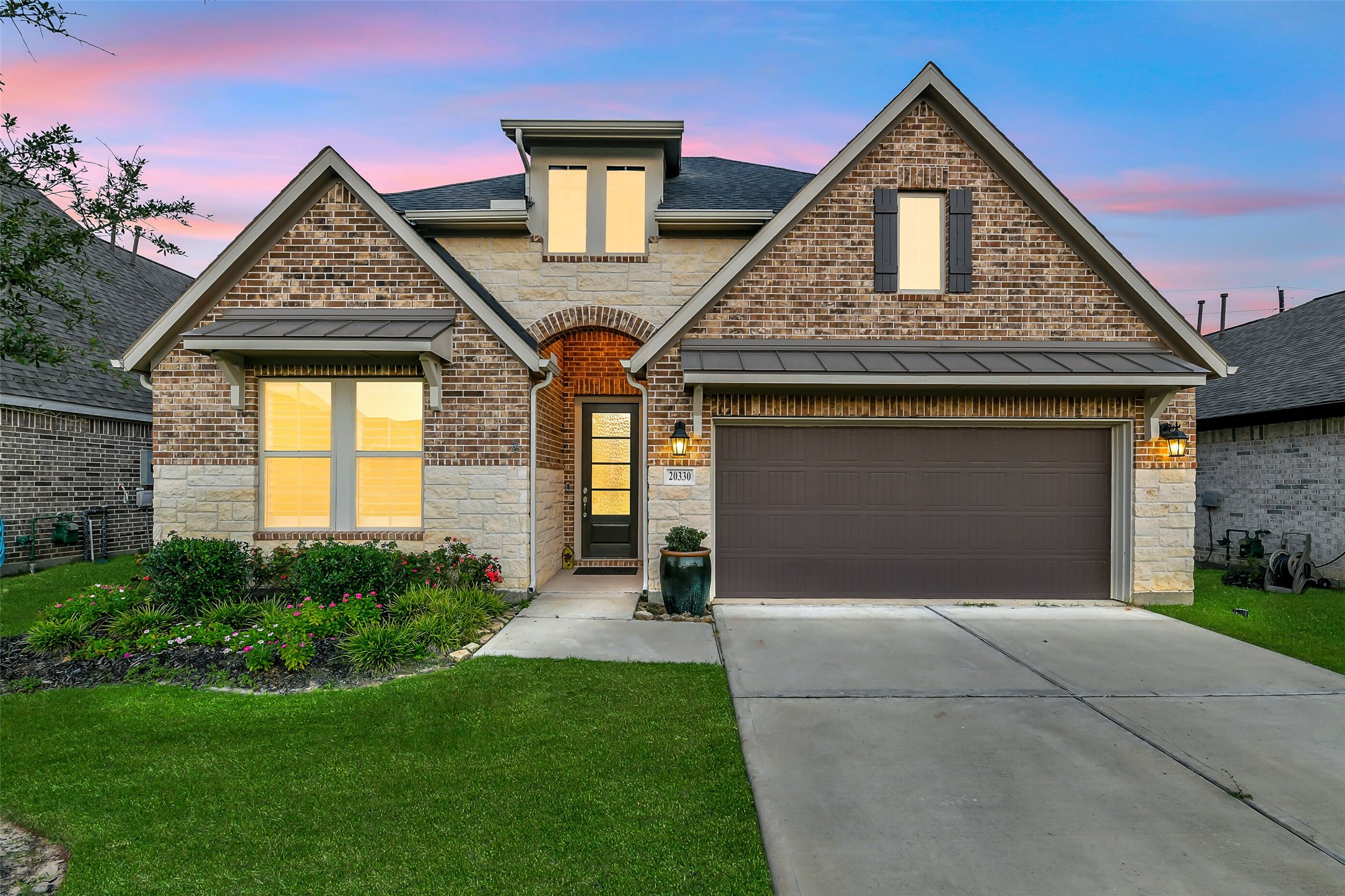 Welcome to 20330 Rose Gray Lane! This gorgeous home features a beautiful brick and stone exterior with easy to maintain landscaping.