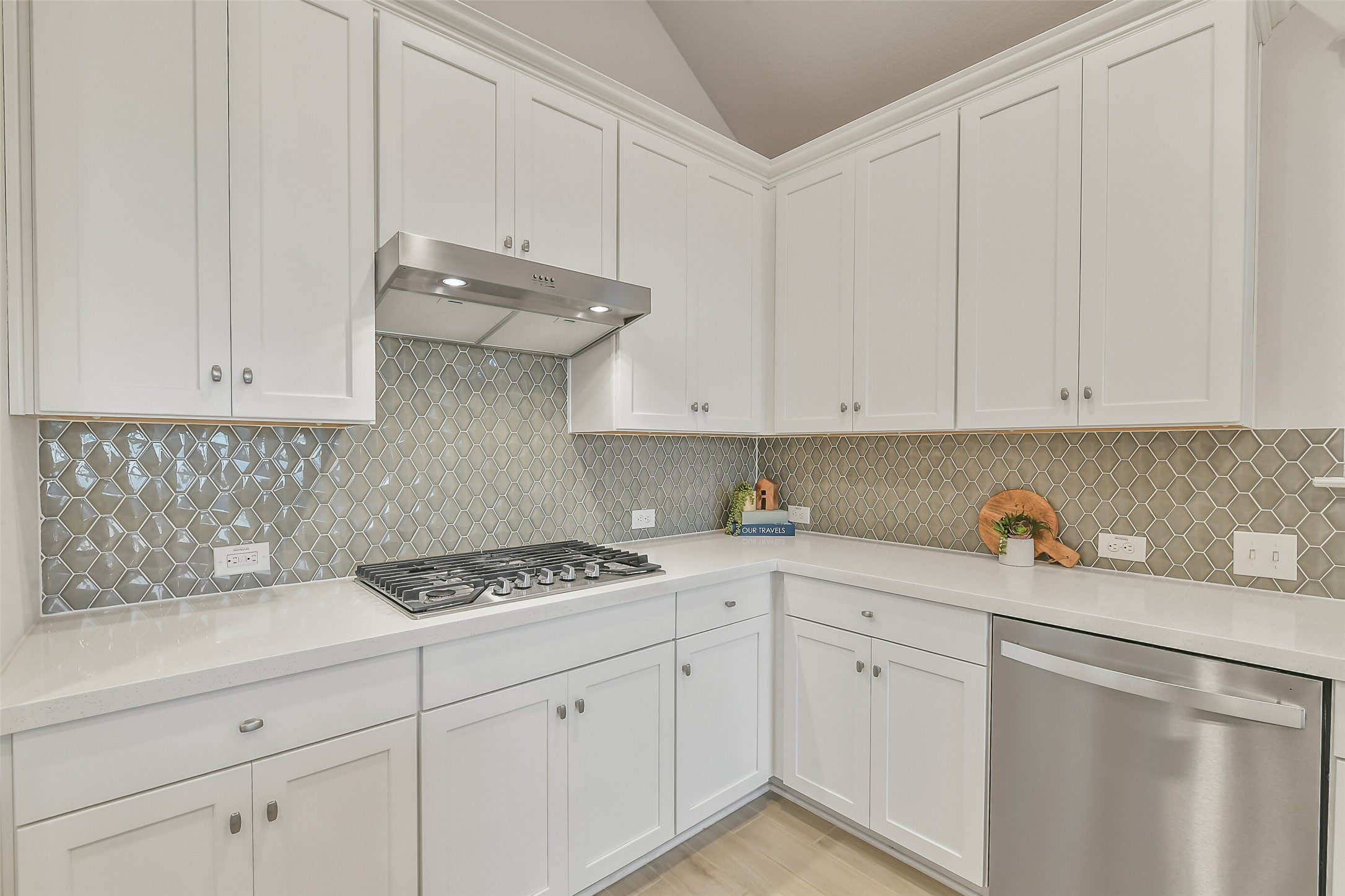 Stainless steel gas stove and vent perfect for cooking your favorite meal.