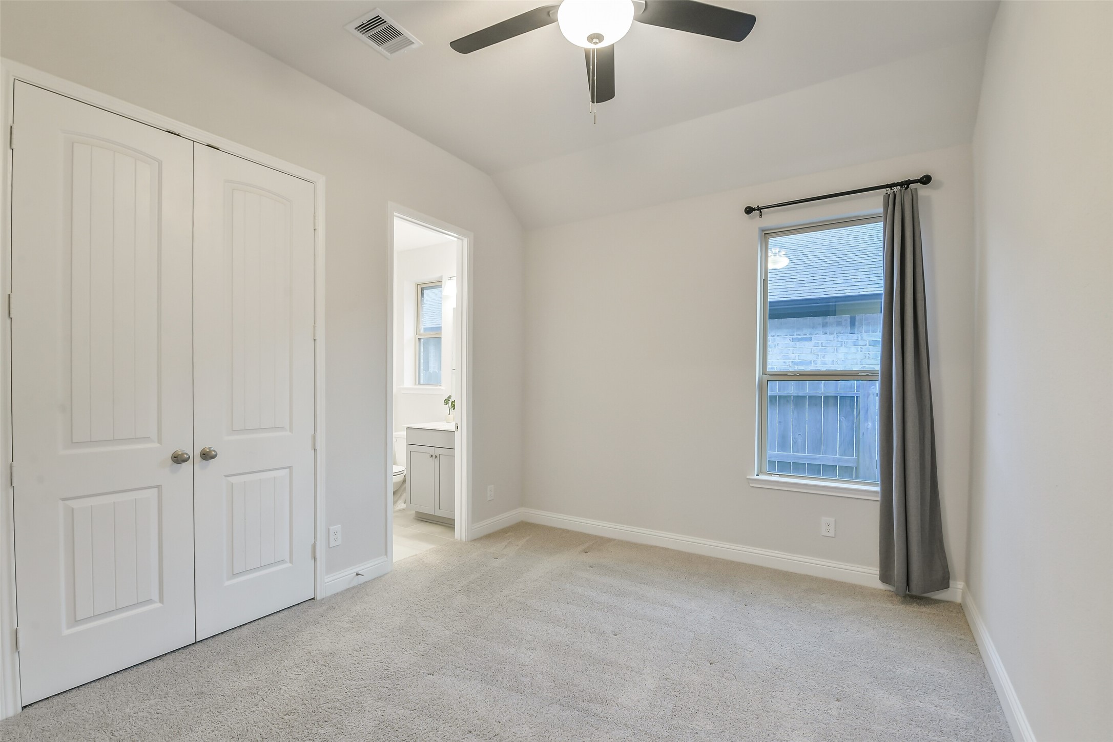 Secondary bedroom #1 with ensuite bath and ceiling fan