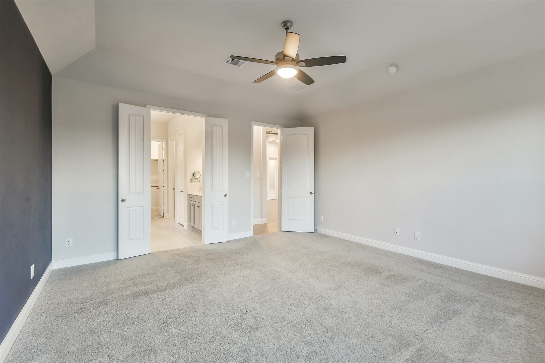 This generous primary bedroom opens to a large ensuite bath.