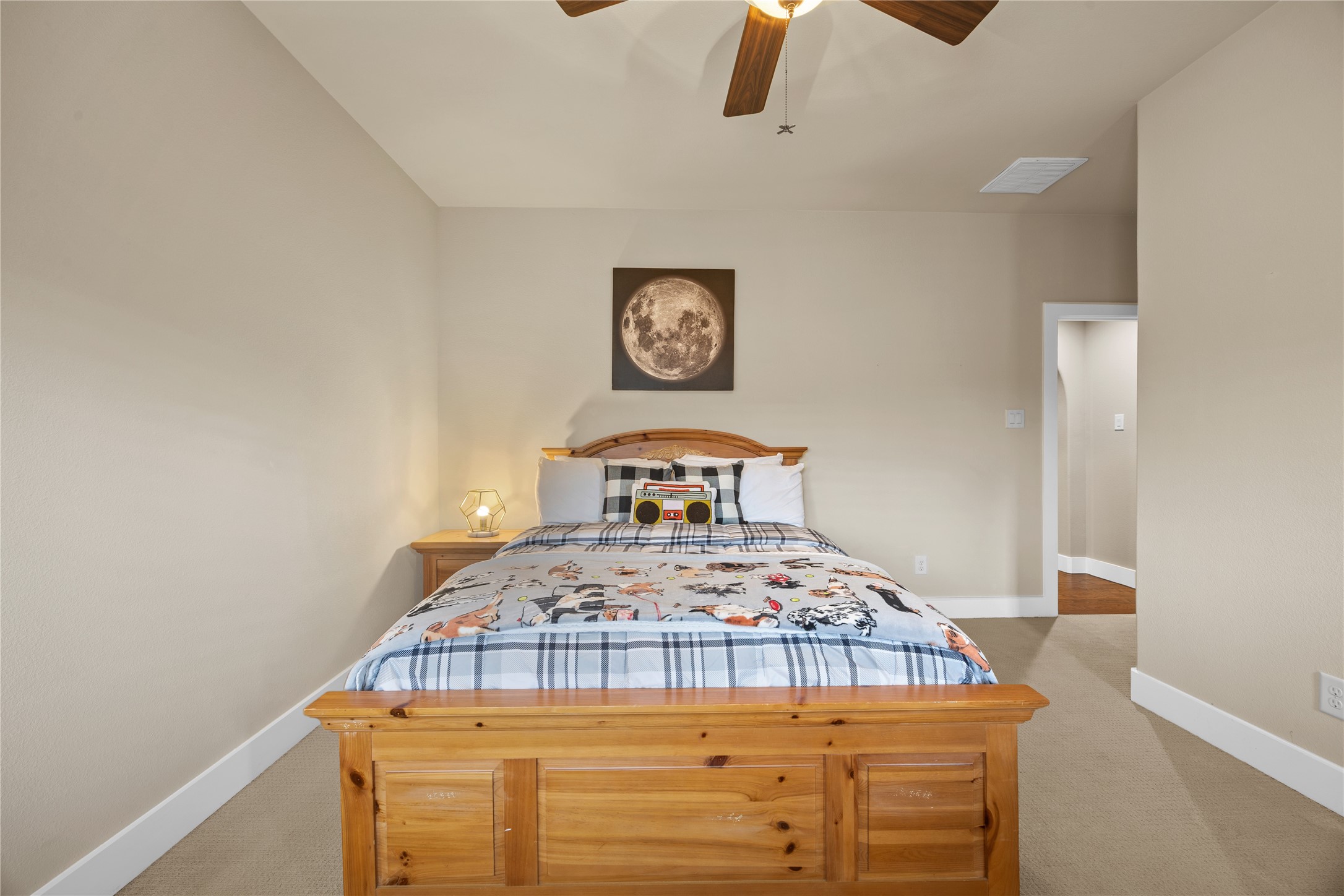Spacious upstairs bedroom featuring a vaulted ceiling, neutral finishes, ceiling fan, and comfortable layout.