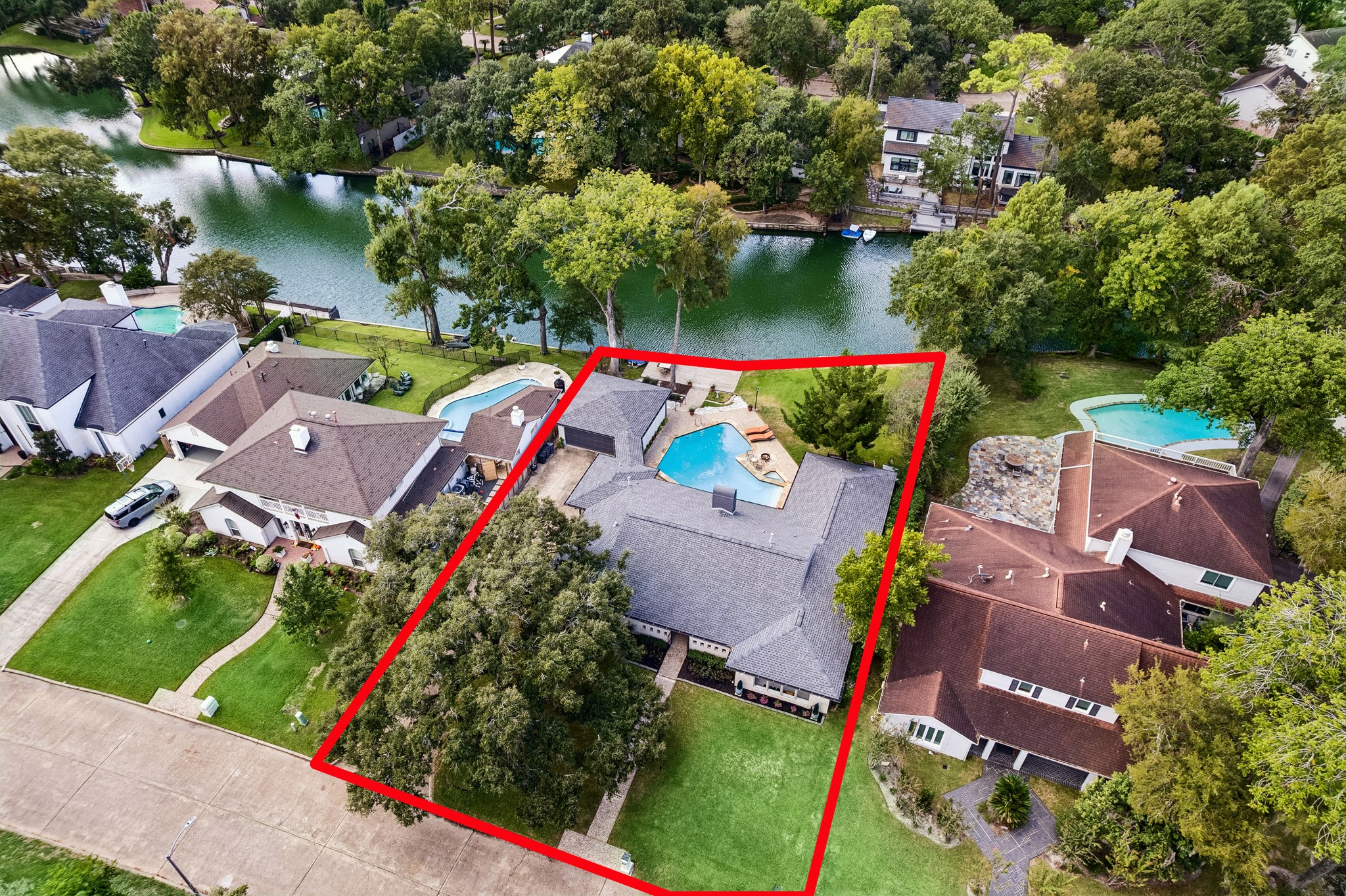 Aerial view showcasing the property's generous lot. This home is ideally located near the end of the cul-de-sac, offering a wonderful blend of privacy, greenery, and scenic waterfront surroundings.