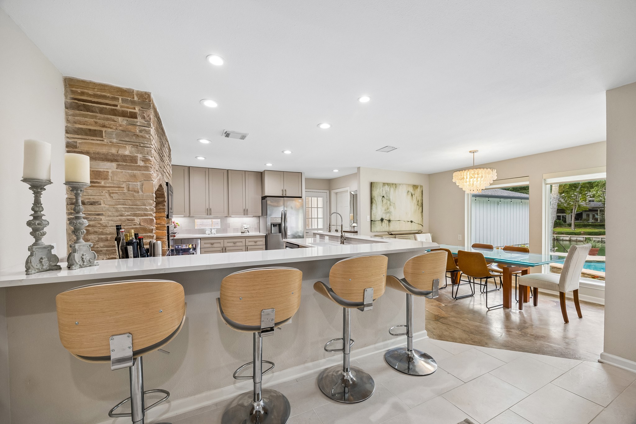 The kitchen is bordered by a large breakfast bar providing space for ample seating and abundant counter space for serving. The kitchen is bordered by a large breakfast bar providing space for ample seating and abundant counter space for serving.