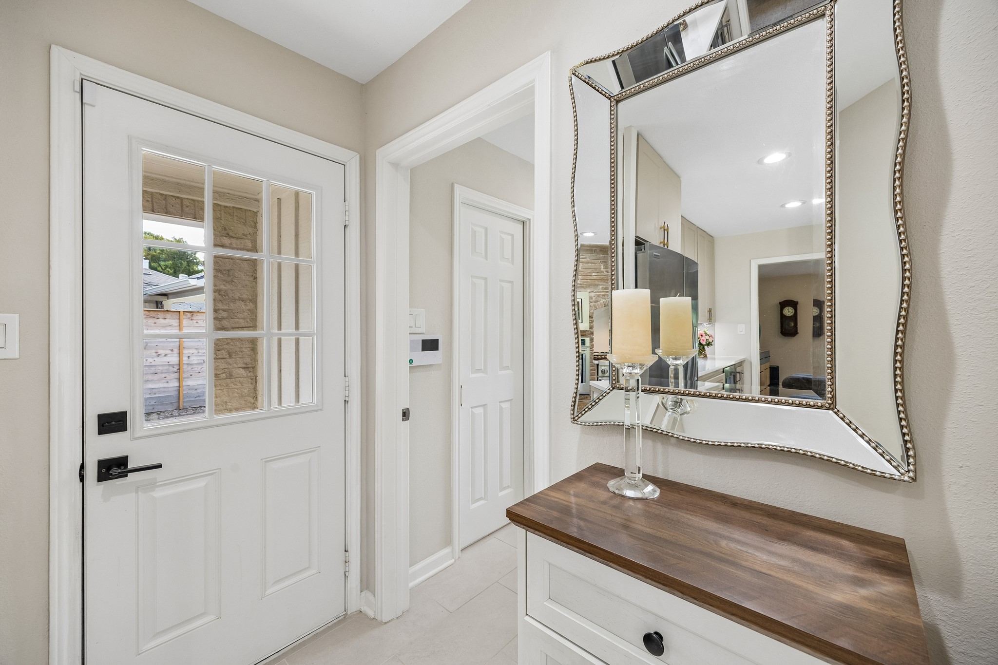 To the right of the side entrance, a hallway leads to the spacious walk-in pantry and conveniently located half bath, also accessible from the pool area.