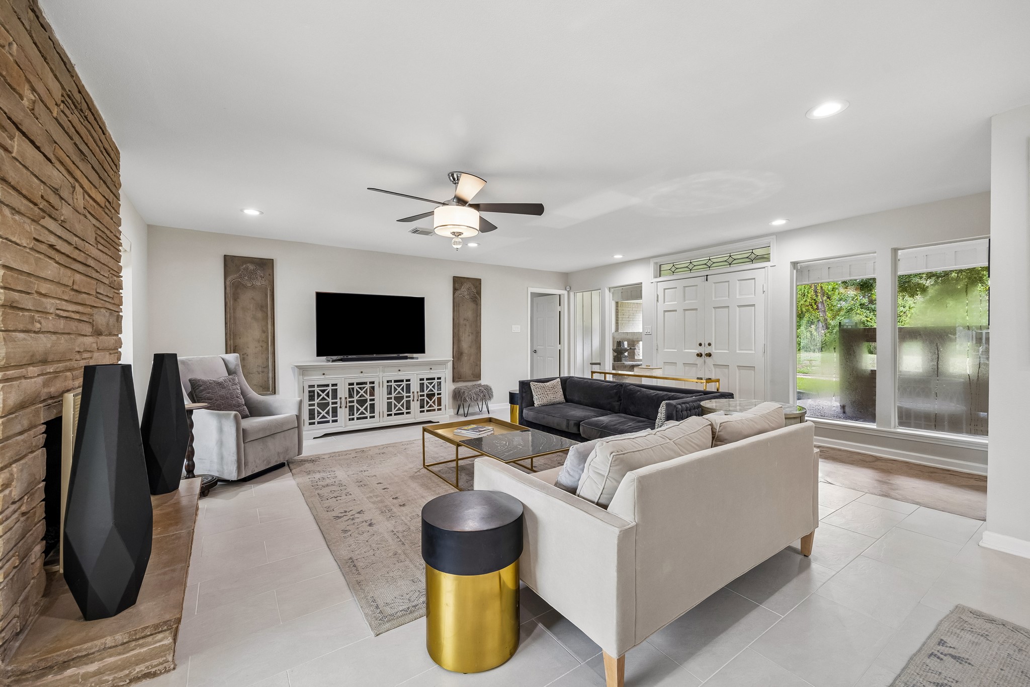 This view shows the living room's generous proportion, with floor to ceiling windows overlooking the front patio. This view shows the living room's generous proportion, with floor to ceiling windows overlooking the front patio.
