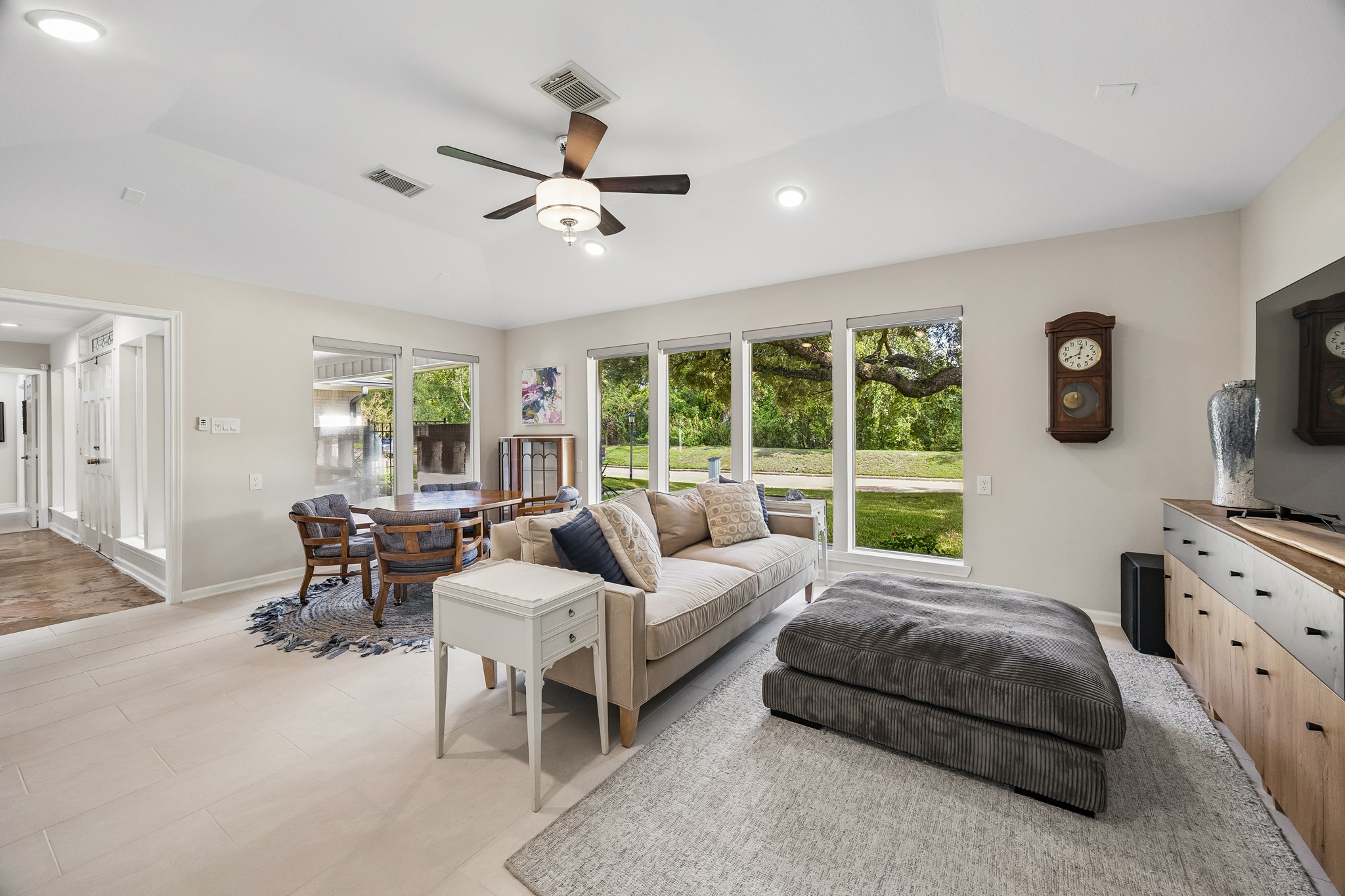 Another view of the spacious gameroom showcasing expansive windows overlooking the front yard and patio.