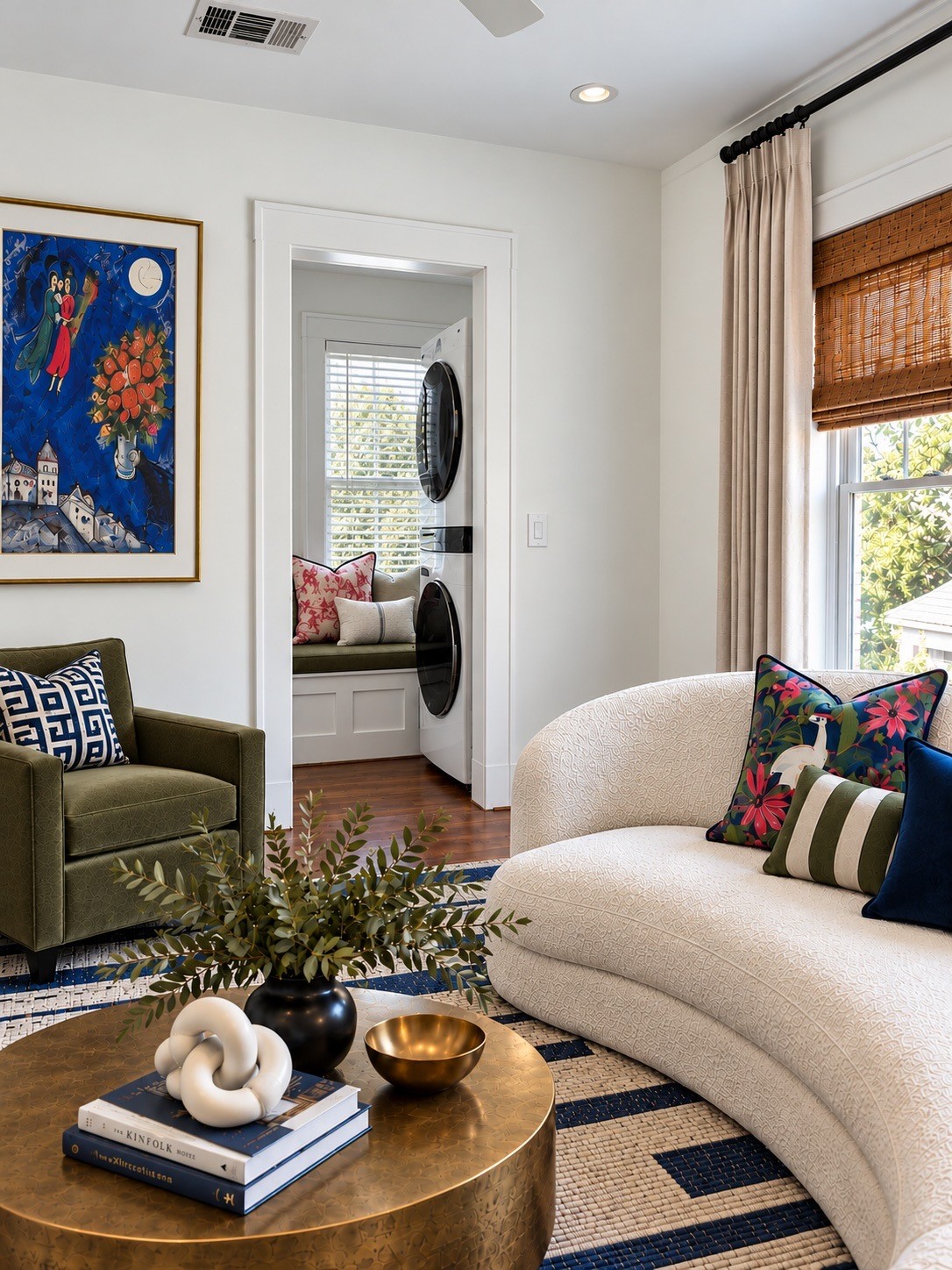 Another view of the generous living area, highlighting its flexible layout and dedicated laundry nook. Virtually staged.