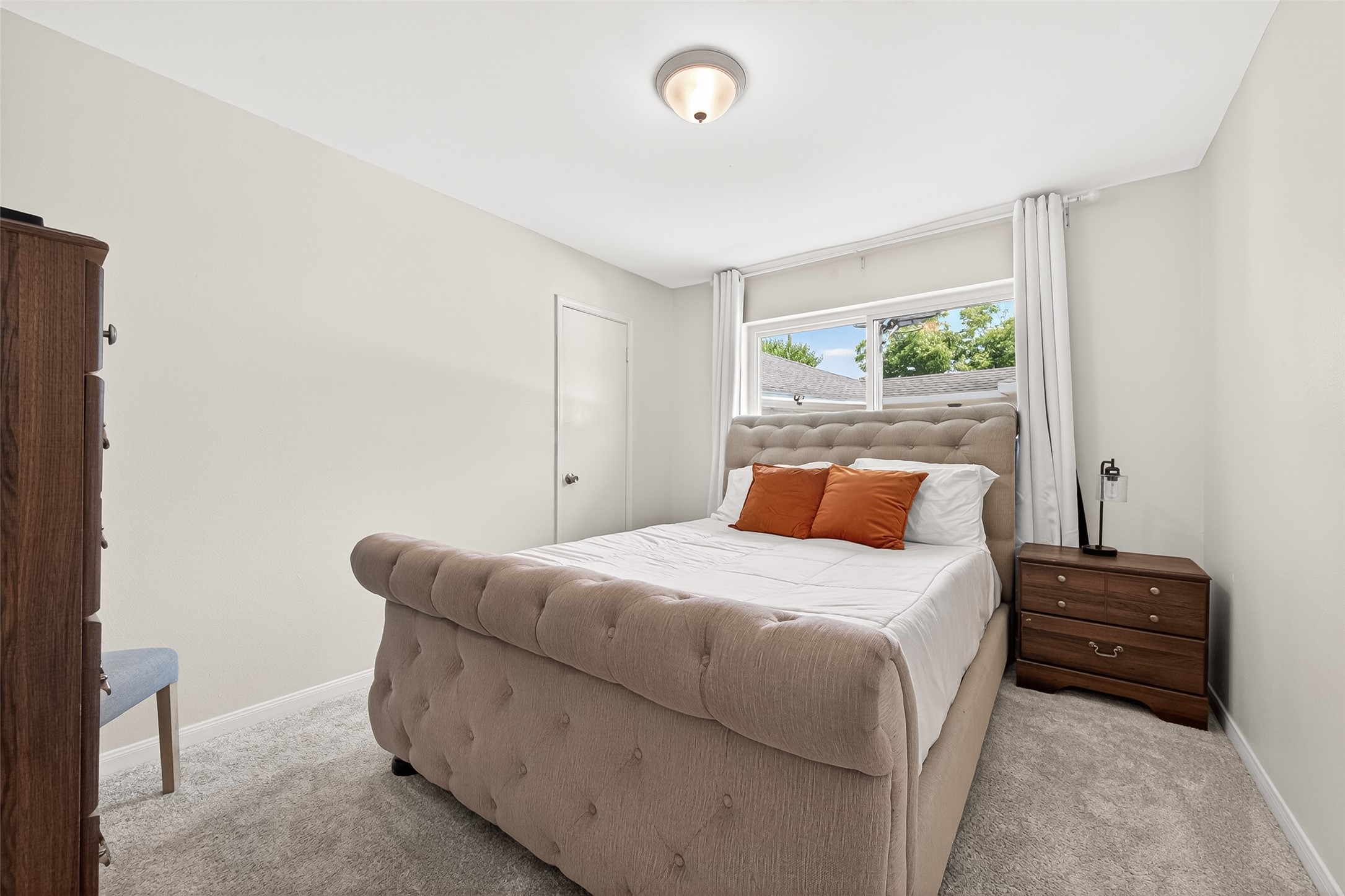 Secondary bedroom with large window.
