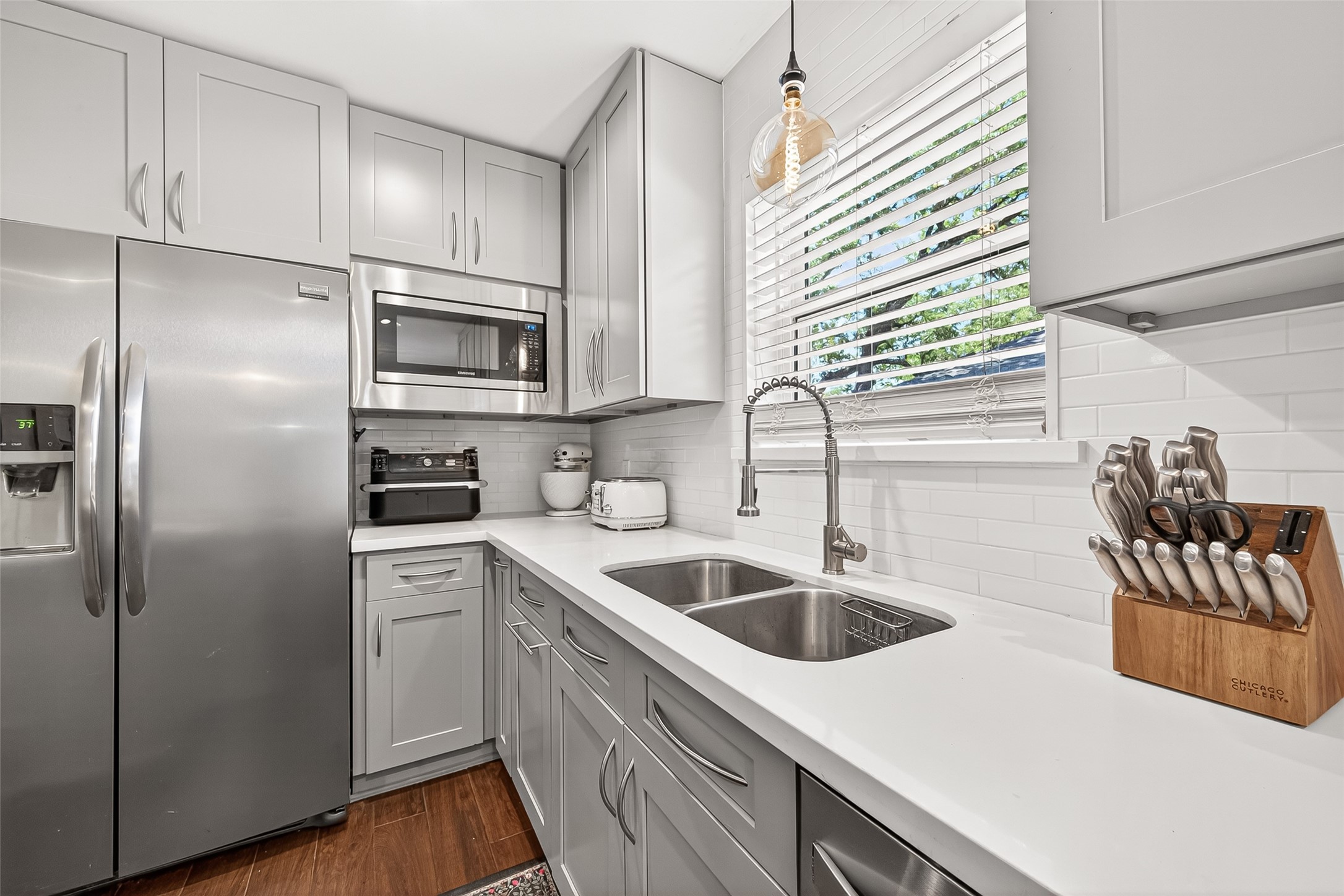 Well-appointed kitchen featuring abundant cabinetry and storage, stainless steel appliances, and an abundance of natural light that enhances the bright, welcoming atmosphere.
