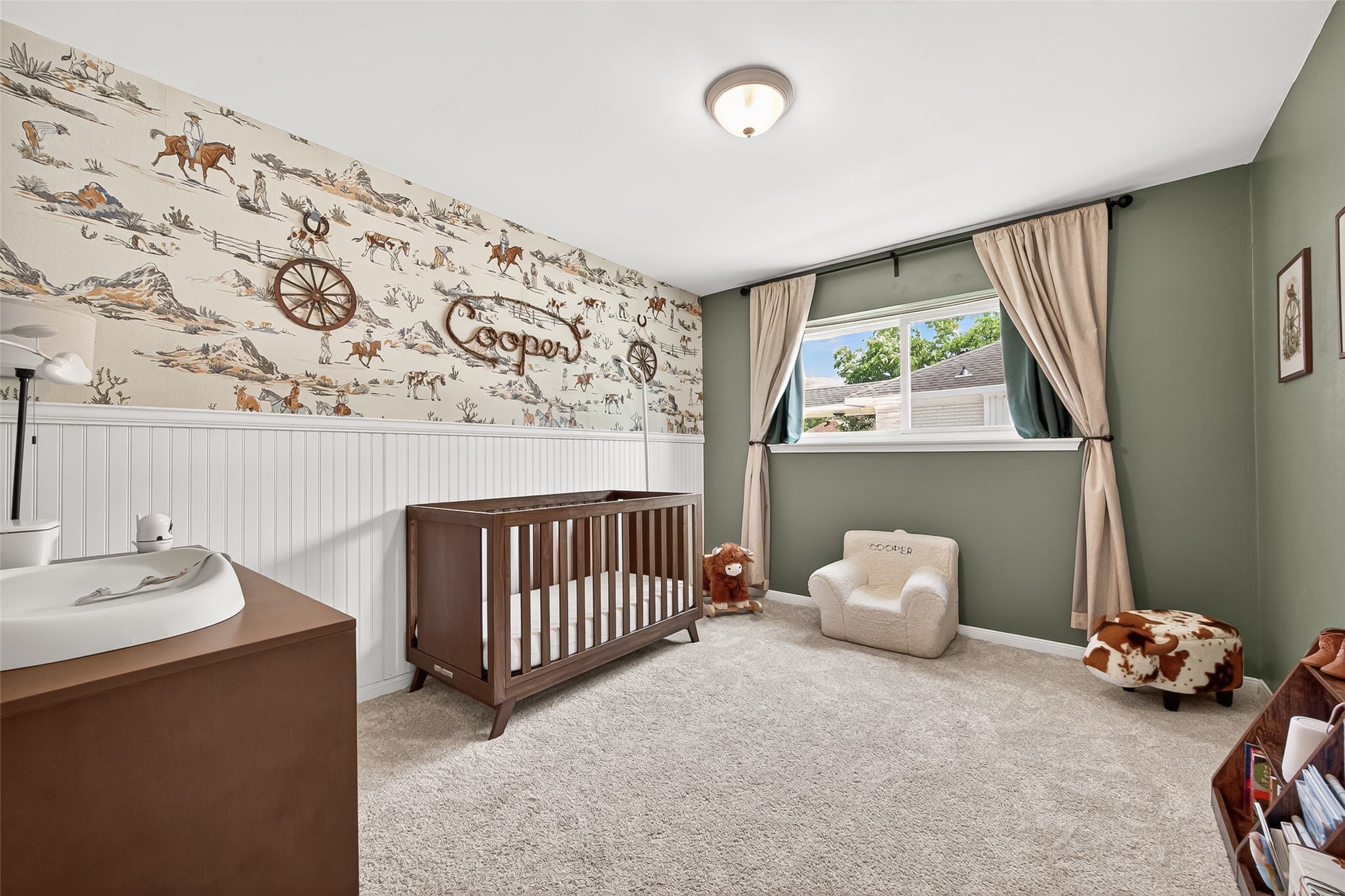 Secondary bedroom with beautiful beadboard. Ample natural light through the large window.