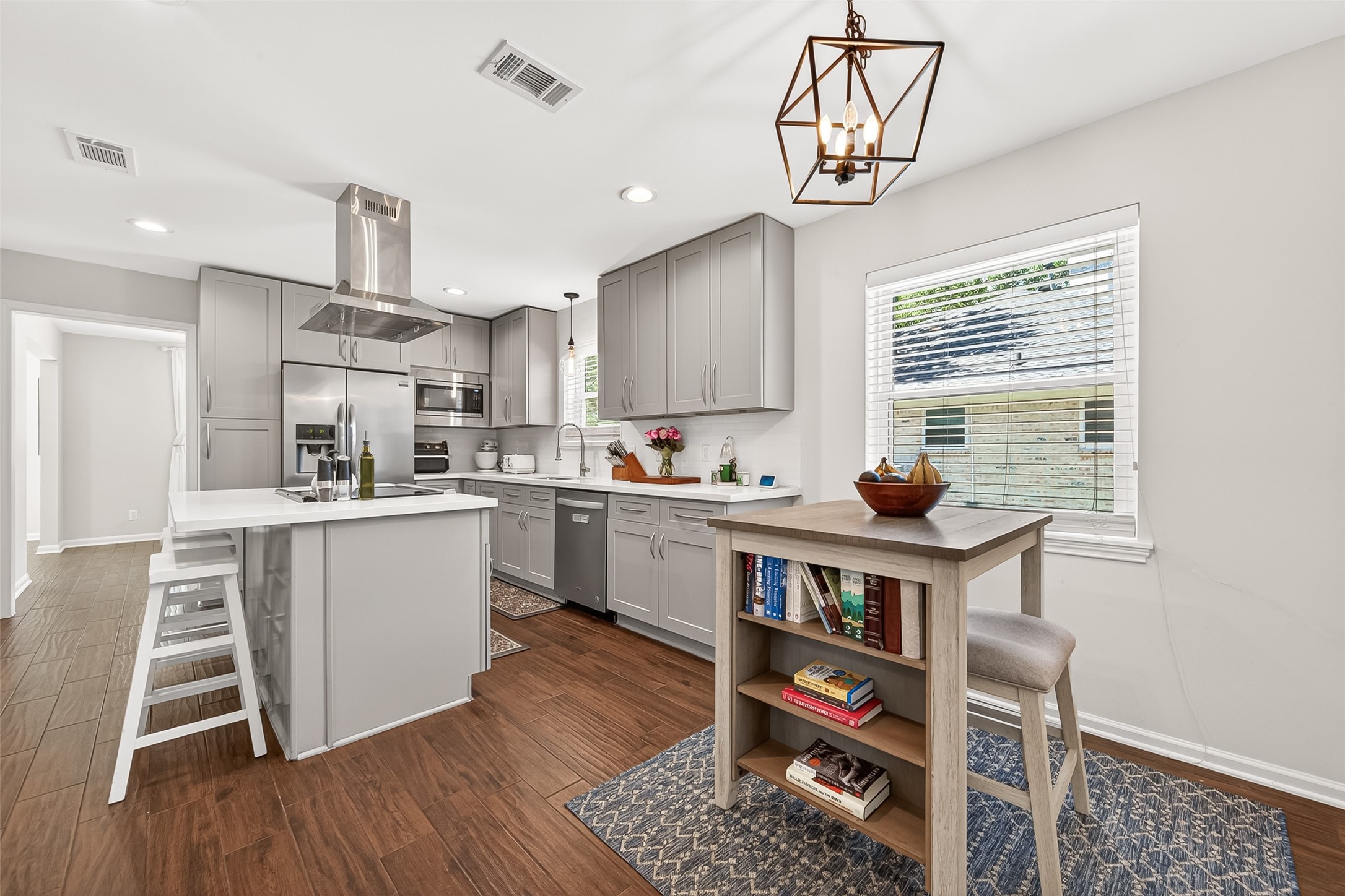Breakfast nook off the kitchen with beautiful light fixture.