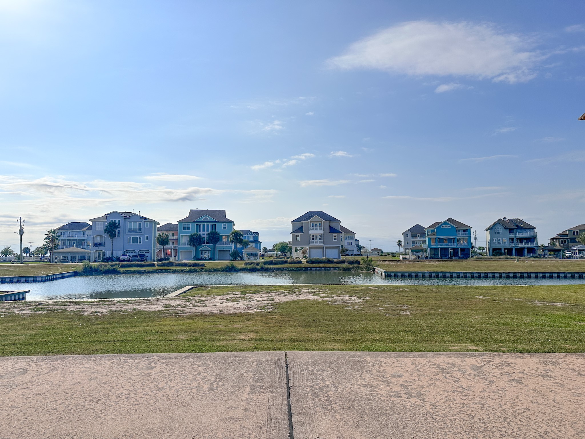 Street view showcasing the homesite to the right, the future boat dock area to the left, and the beautiful landscaped preserve directly across the canalwhere no homes can be built, helping preserve your peaceful  view.