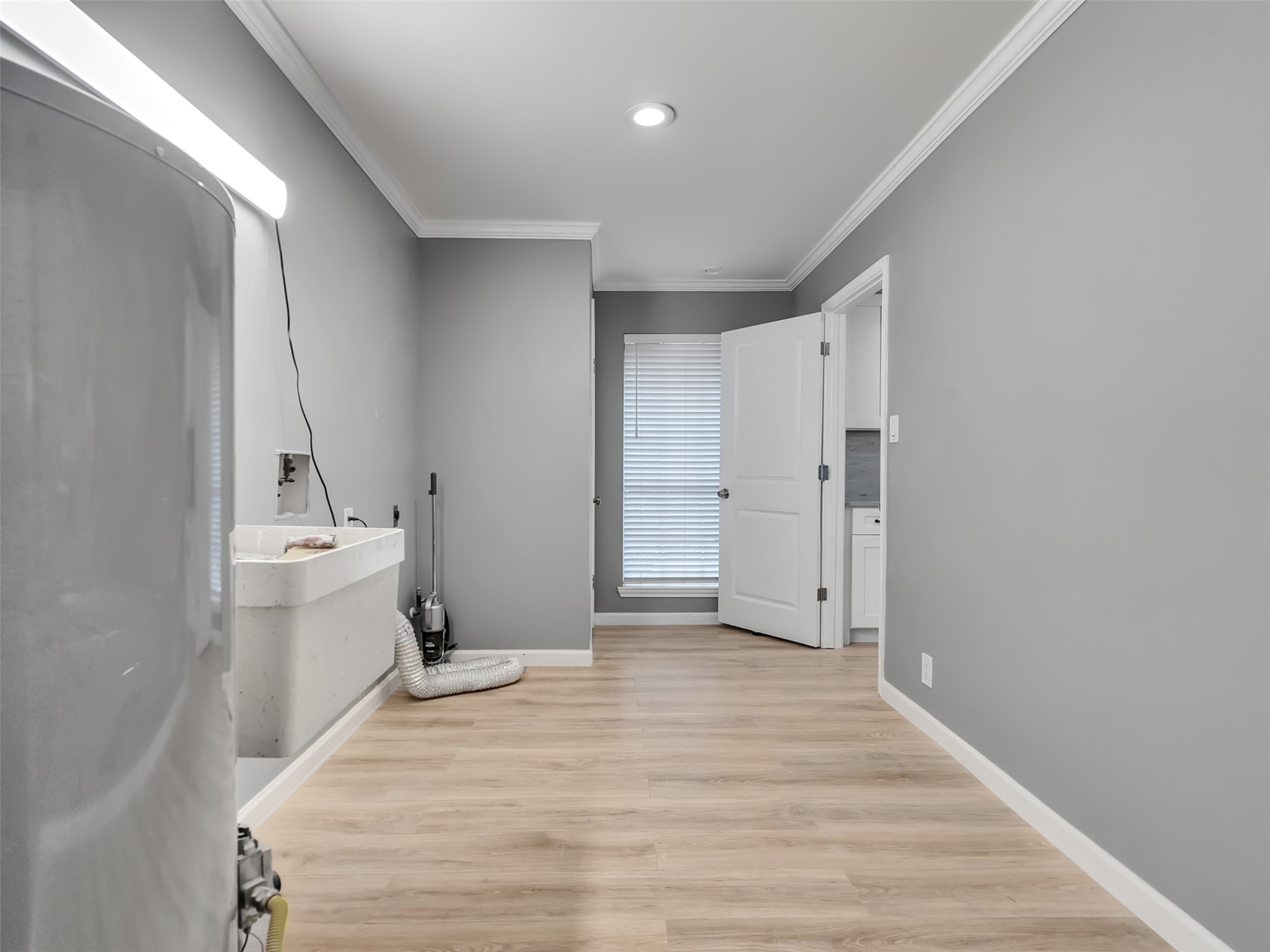 Expansive Laundry Room leading to newly completed downstairs primary suite.