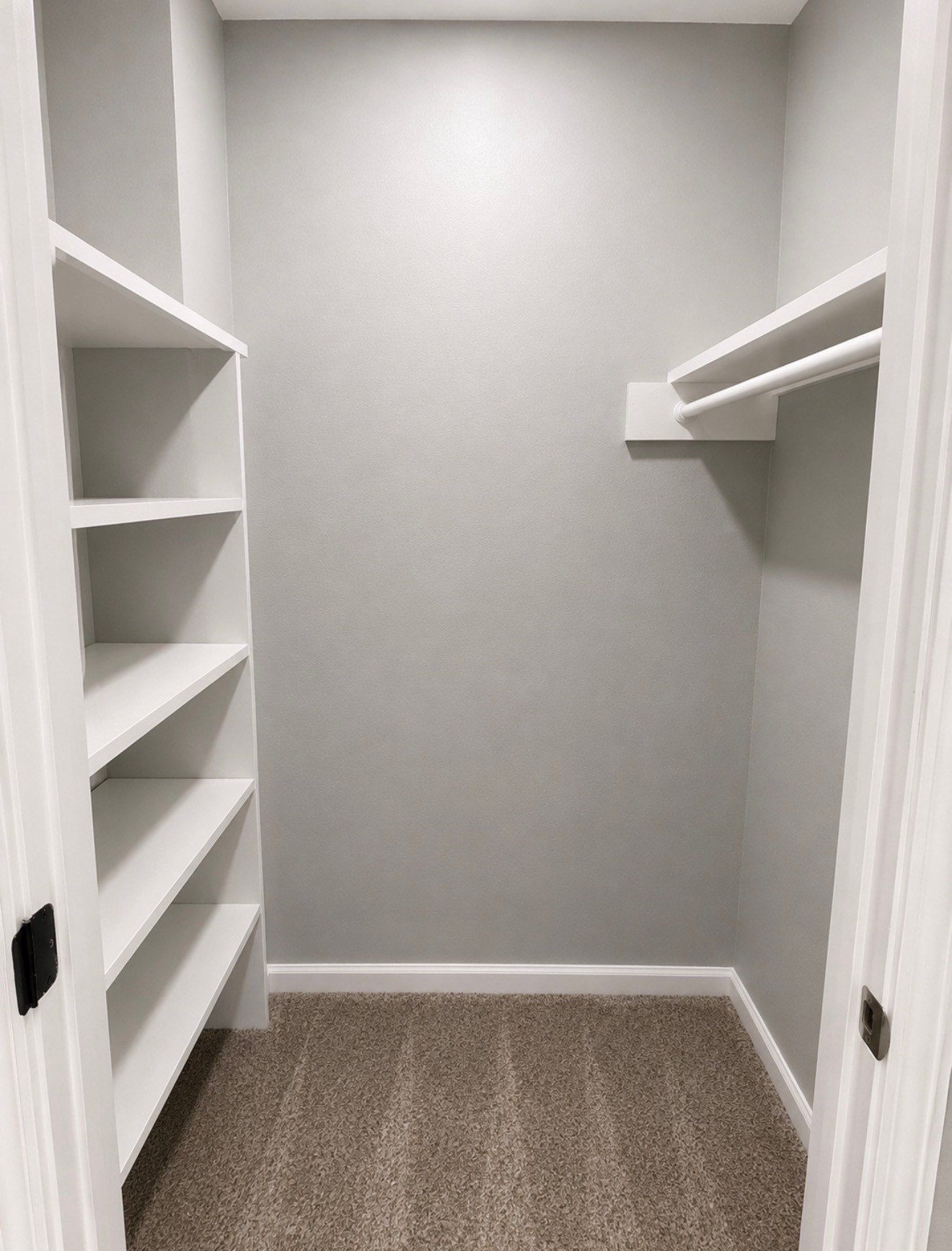 Massive walk-in storage closet for games or holiday decor at top of stairs.