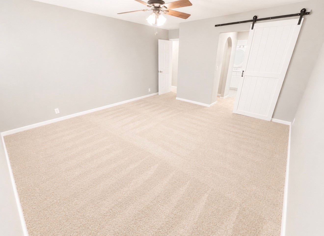 Primary bedroom with full ensuite bathroom and his and her closets.