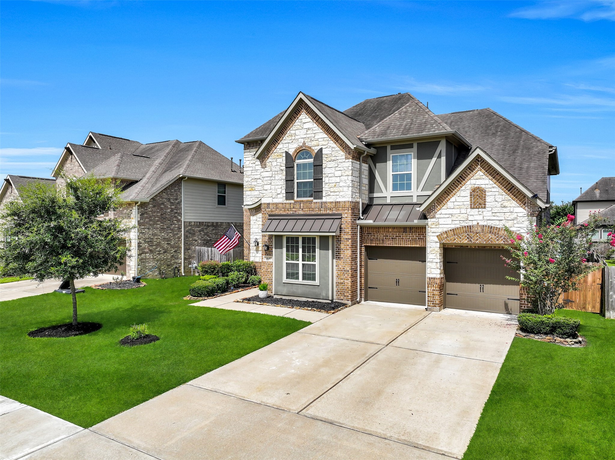 From the charming covered front porch with an 8' iron-and-glass entry door to the striking blend of brick, stone, stucco, and wood accents, this beautiful West Ranch home makes a lasting first impression. Fresh landscaping, carriage-style garage doors, and a double-wide driveway complete the timeless curb appeal.