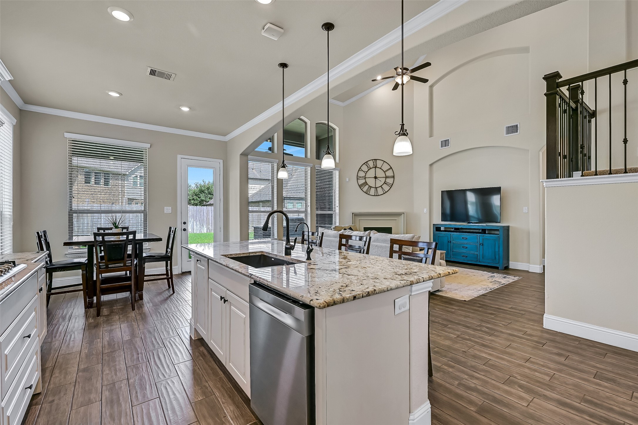 The open-concept design truly shines from the kitchen, where an oversized granite island overlooks the breakfast area and dramatic two-story family room. Whether preparing dinner, helping with homework, or hosting friends, this thoughtfully designed space keeps everyone connected while enjoying beautiful backyard views.