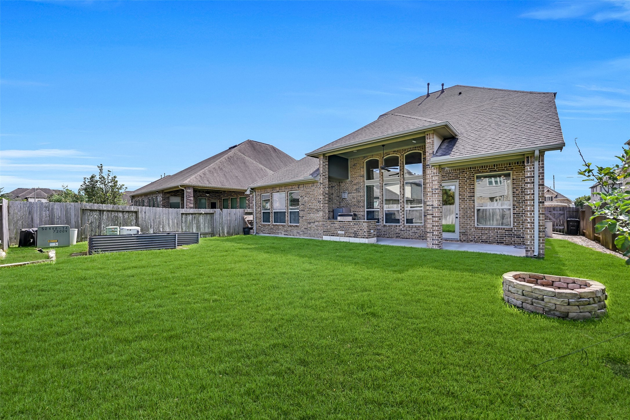 A lush backyard provides plenty of room for kids, pets, or future outdoor additions, while the fire pit creates the perfect place to gather on cool Texas evenings. Raised garden beds offer space to grow your own flowers, herbs, or vegetables, and the included 24kW Generac whole-home generator delivers valuable peace of mind year-round.