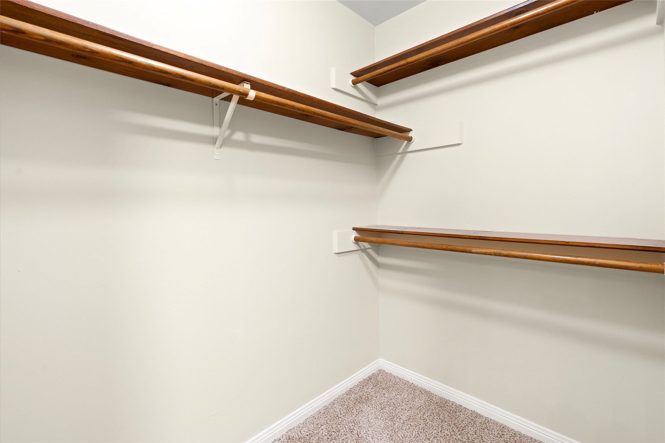 There are 2 walk in closets with shelving in the primary bath.