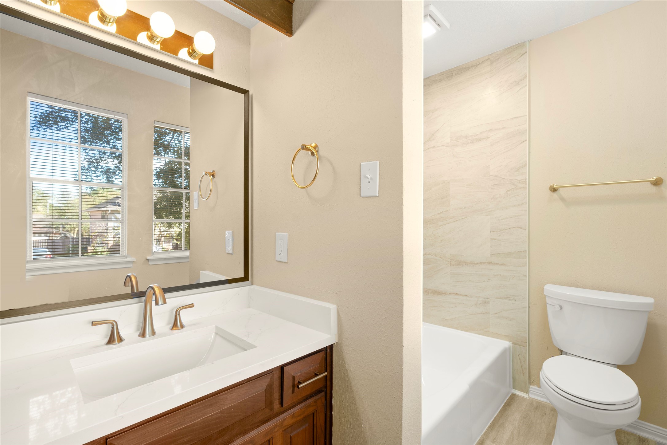 The 2nd bath was also updated with new tile and refinished bathtub. Tiles go to the ceiling for a contemporary feel.