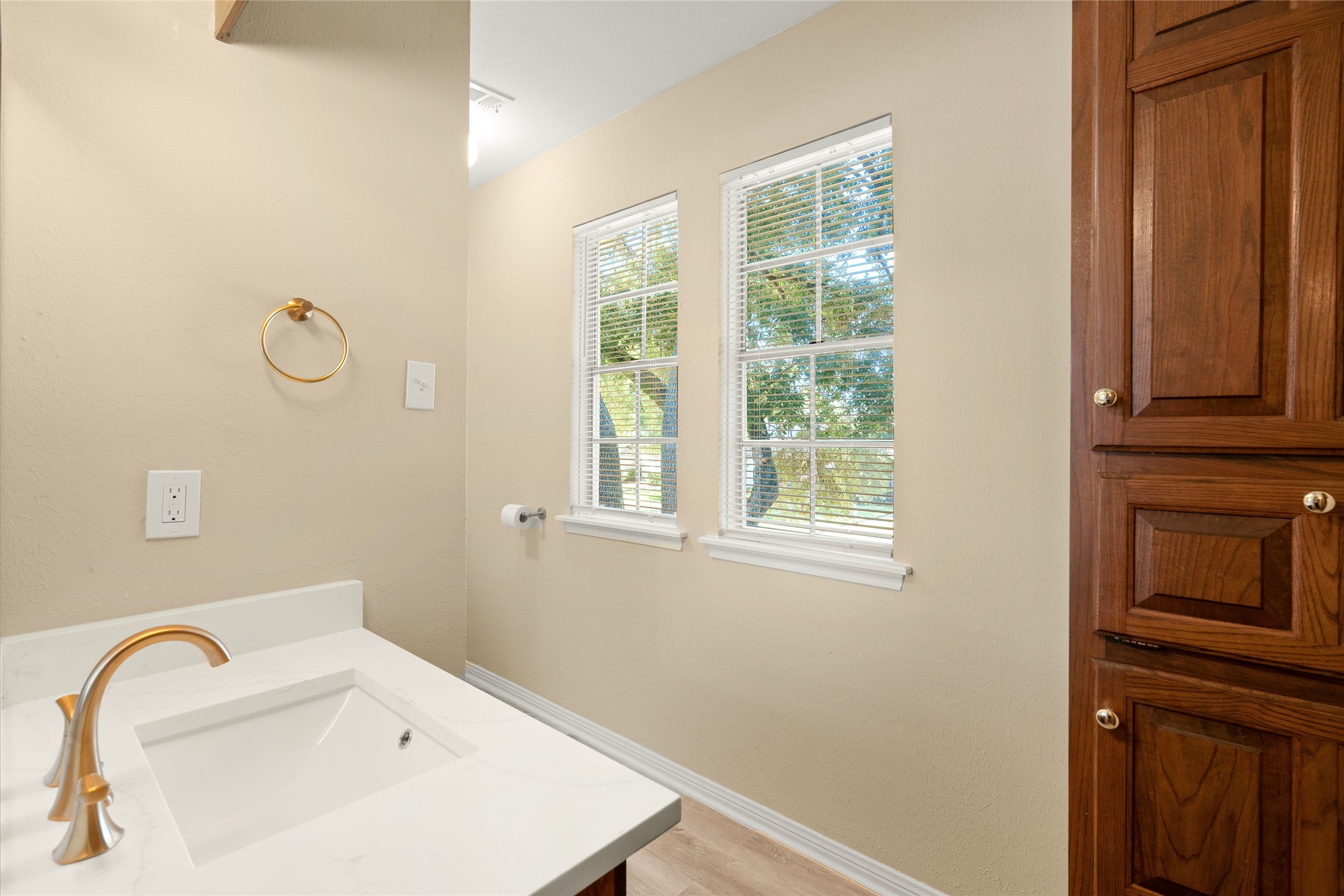 Windows in the 2nd bath provide natural light. There's also a linen close with storage options.