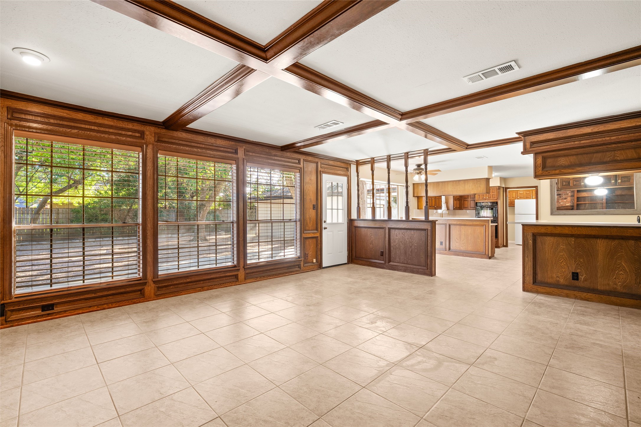 Walls of windows flank the family room to the kitchen.