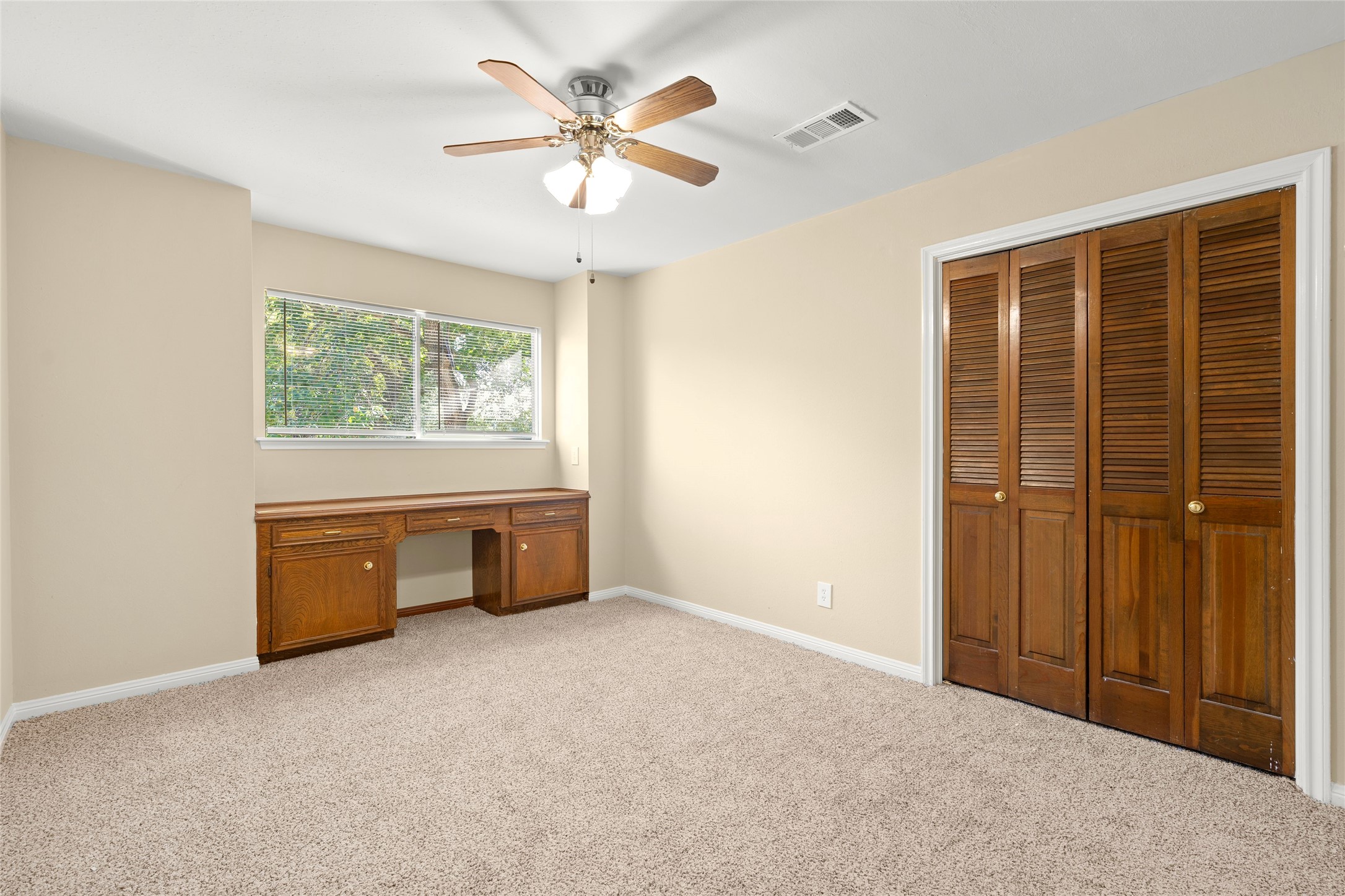 The 2nd and third bedrooms are larger than most new construction homes. This 2nd bedroom has a built in study desk or workspace.
