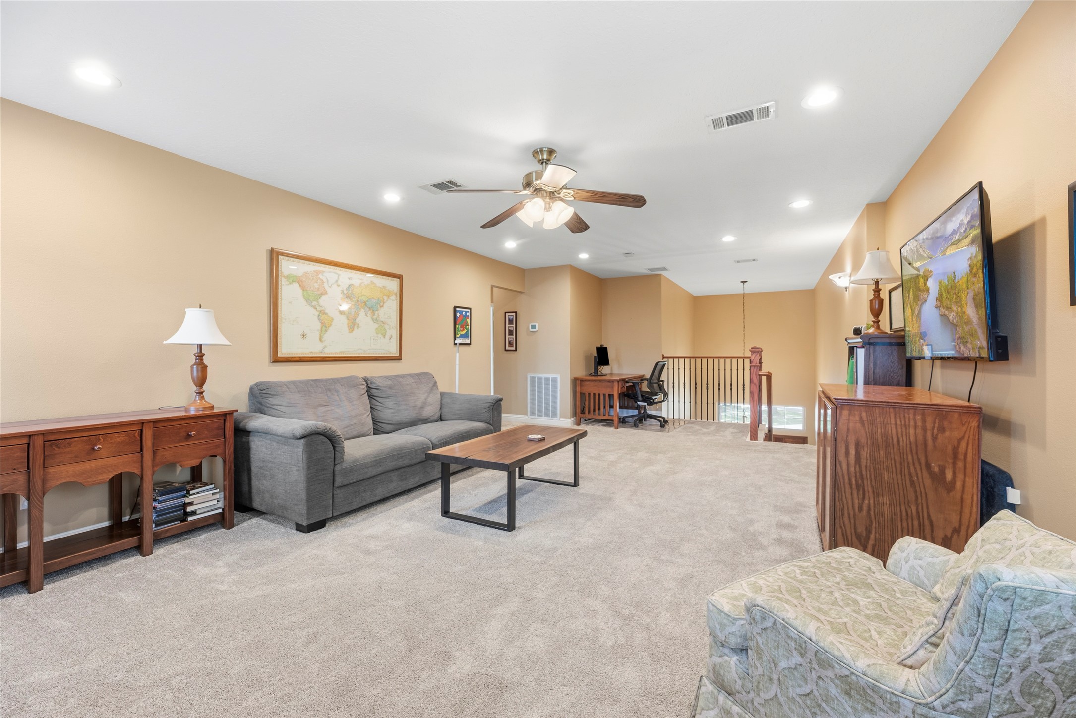Upstairs you'll find a versatile game room with plush carpet and a ceiling fan.