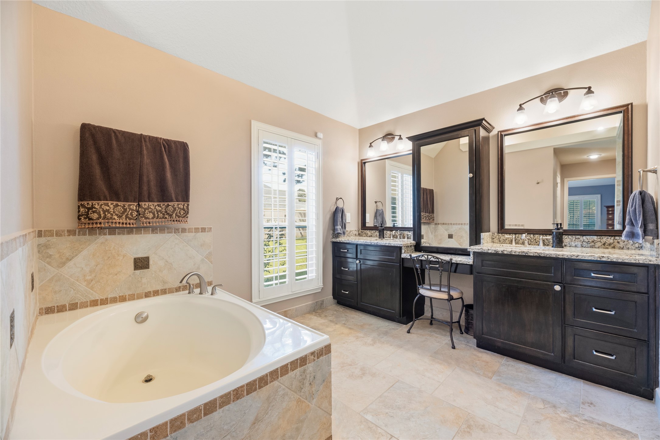 Primary bathroom is complete with a dual sink granite vanity, soaking tub and separate shower.