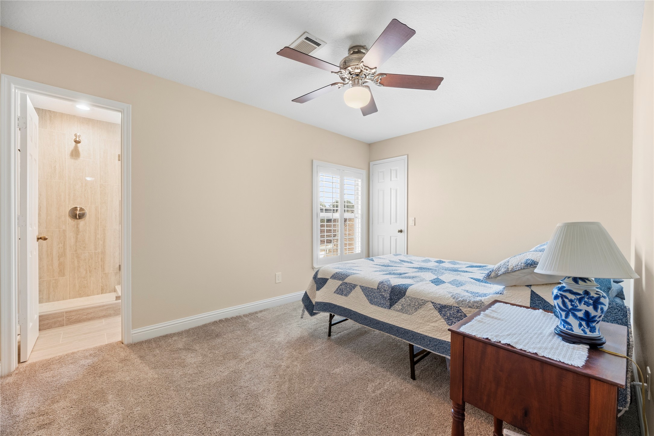 All secondary bedrooms include plush carpet, ceiling fans and large closets. This bedroom has an en-suite bathroom.