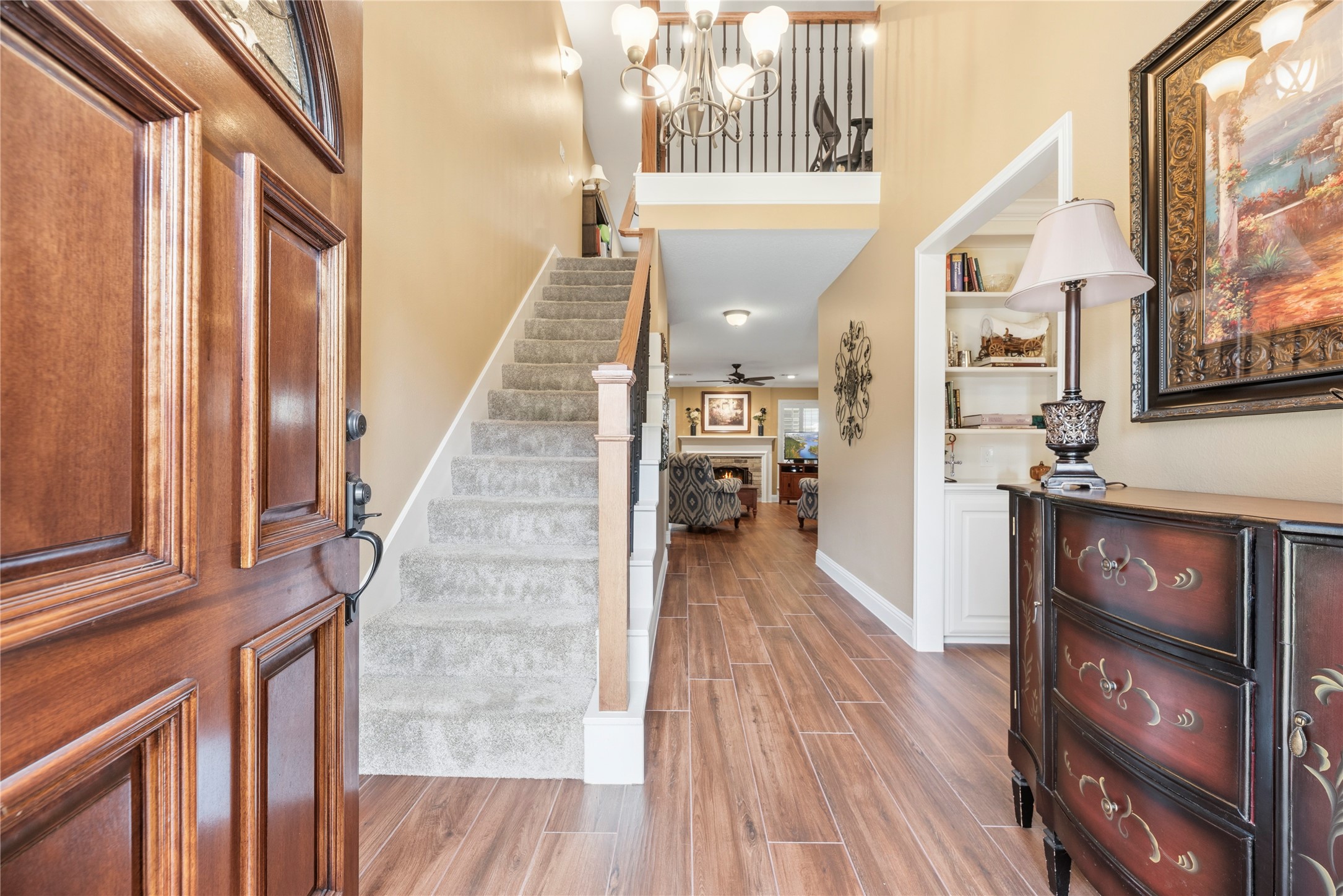 Inviting front entry offers a high ceiling and wood-look tile flooring.