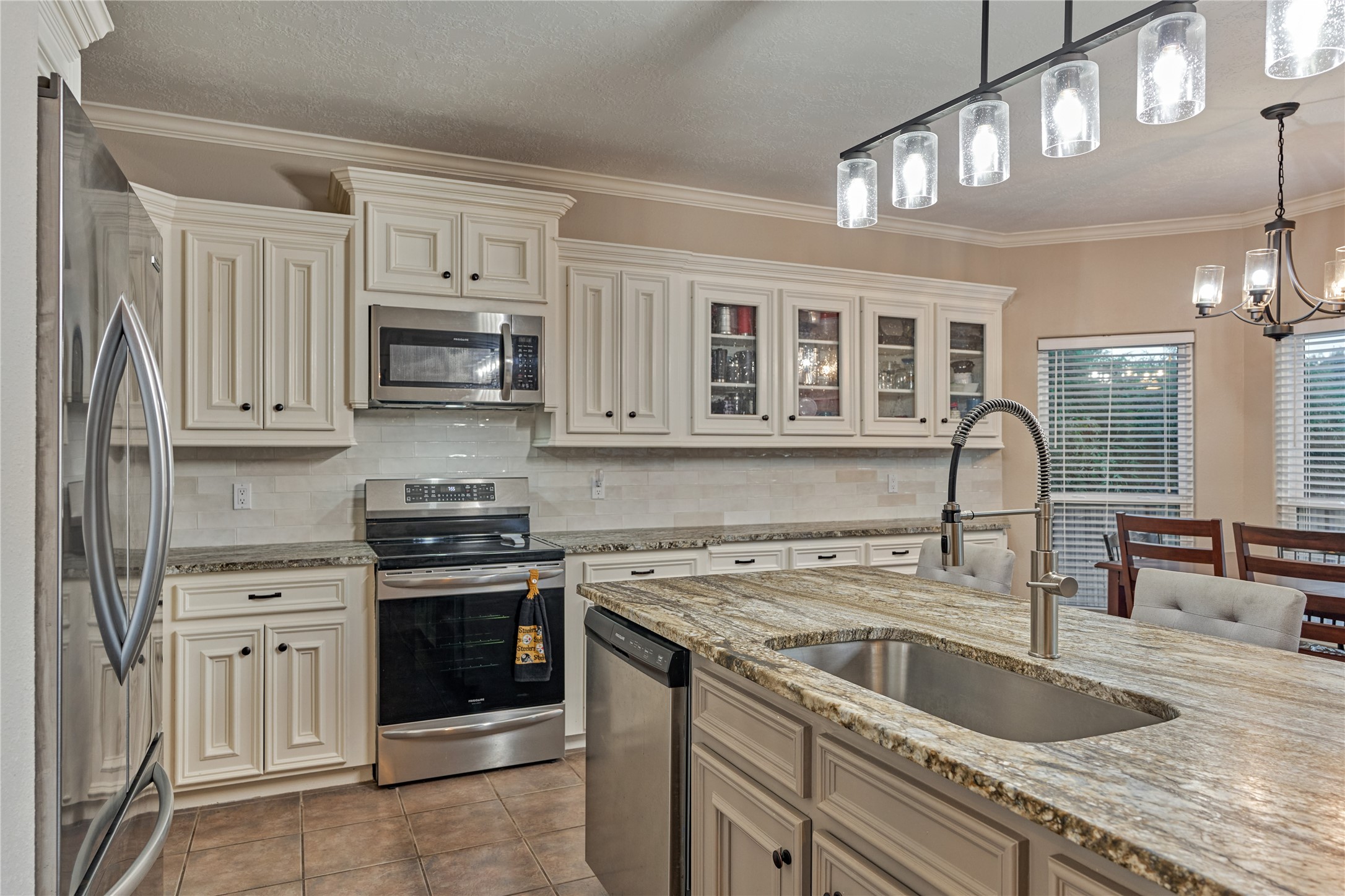 An abundance of crisp white cabinetry provides ample storage for all your kitchen tools and appliances, keeping the space beautifully organized and clutter-free.