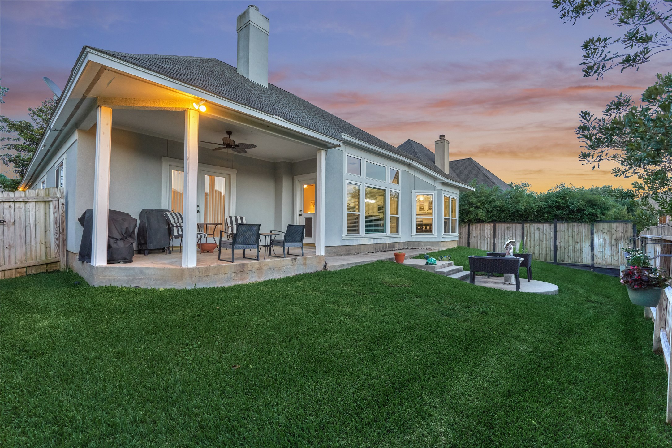 Inviting backyard with a covered patio, perfect for entertaining and comfortable outdoor living.
