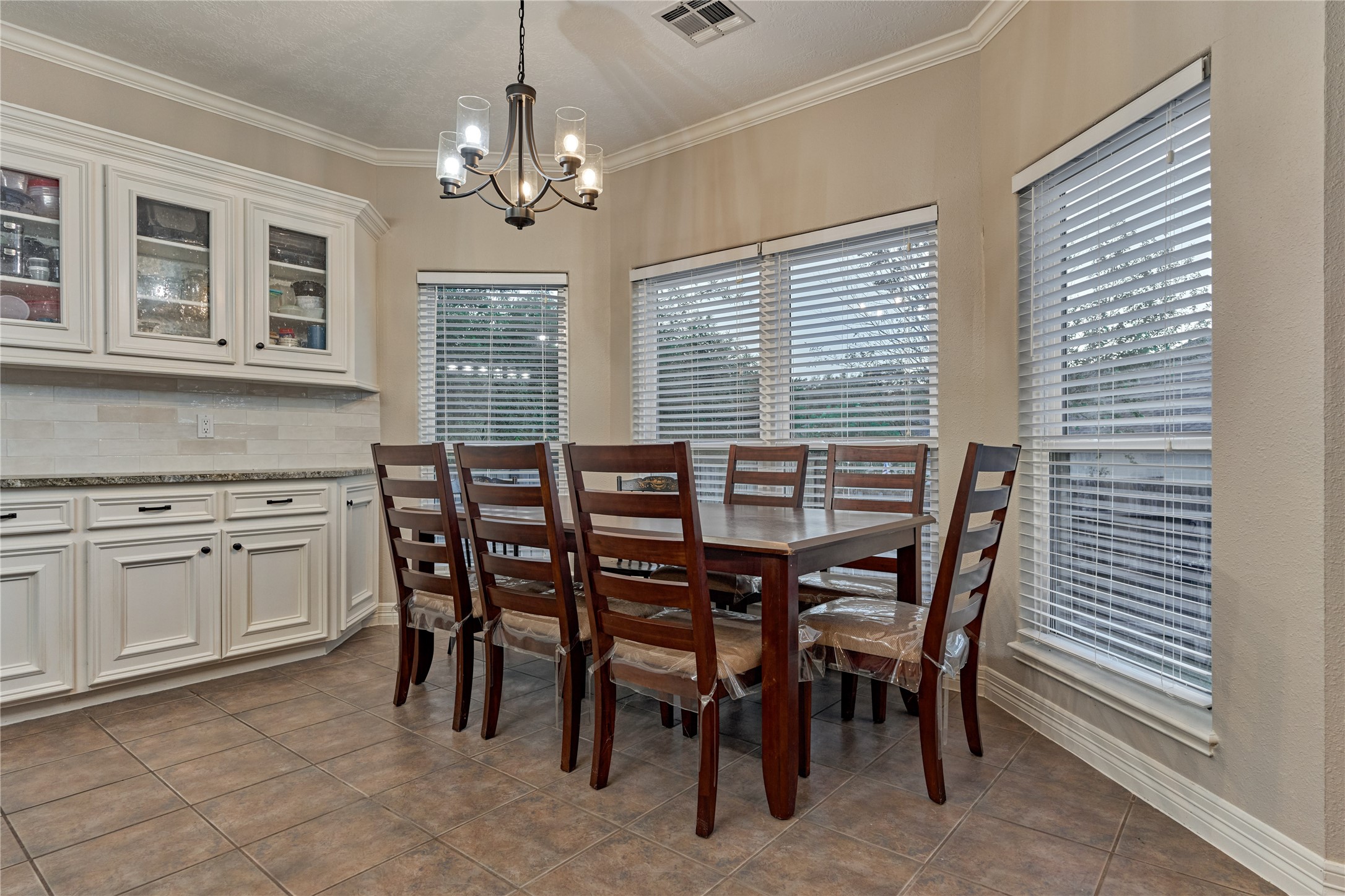 Spacious breakfast/dining room showcases a wall-of-windows that fills the space with natural light and provides beautiful views of the backyard.