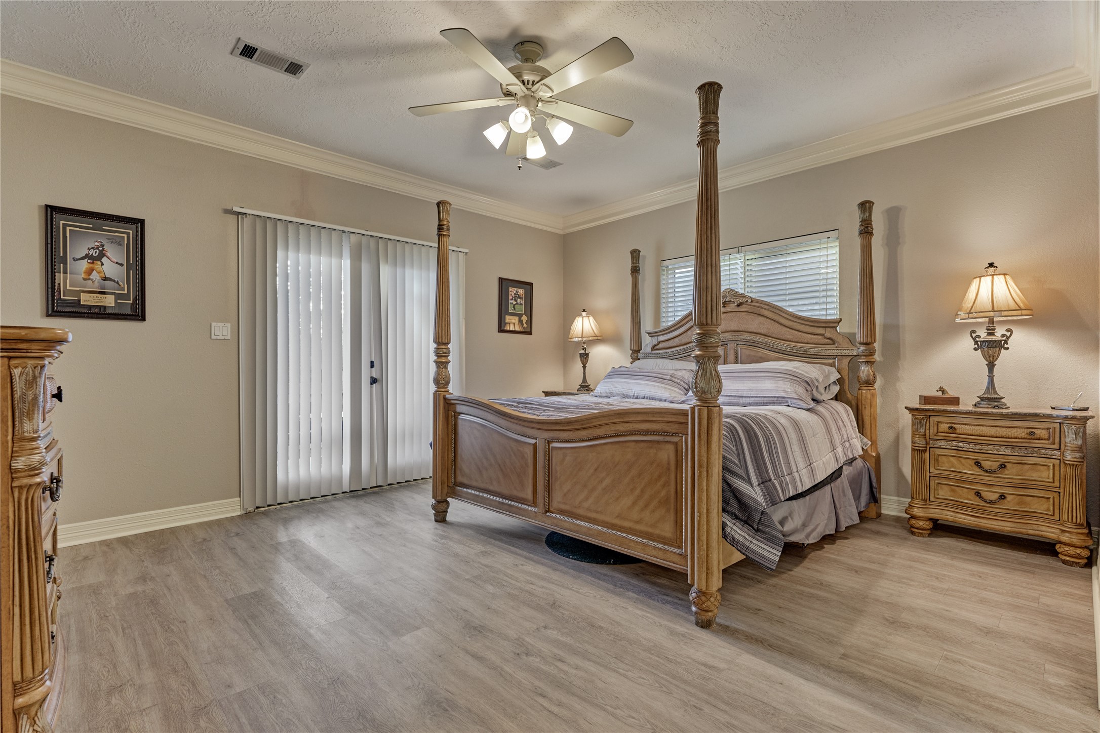 Owners retreat showcases updated flooring, a huge walk-in closet, and offers direct access to the patio and backyard through elegant French doors,
