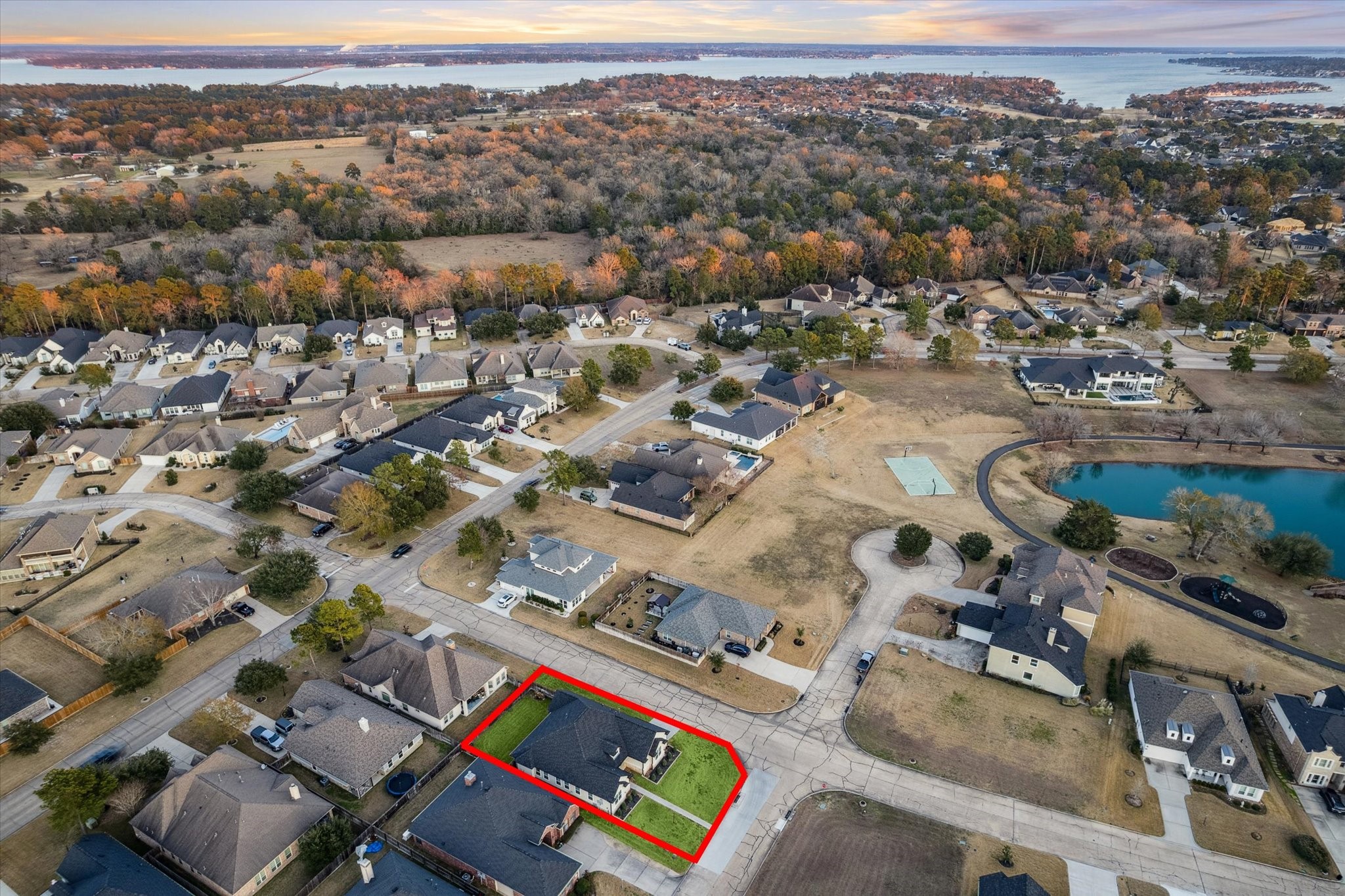 This aerial angle highlights the propertys prime location, conveniently situated near the pond. Set within a beautiful and well-established neighborhood, this home offers both charm and convenience.