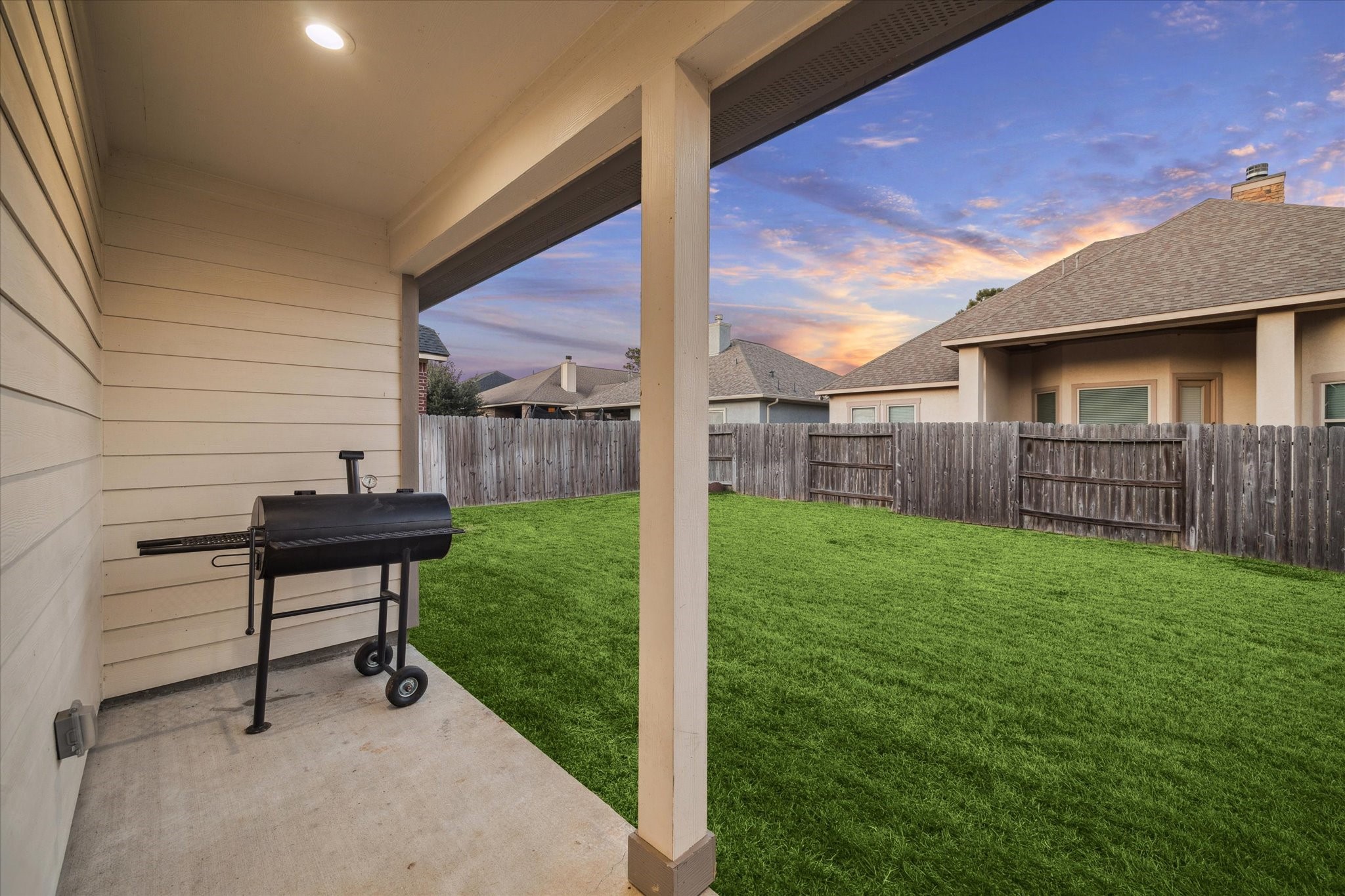This cozy covered patio highlights the spacious, fenced backyard, perfect for adding a pool, a large playground for children, or a firepit. Ideal for enjoying afternoons with family and friends, this inviting outdoor space combines comfort, functionality, and charm.